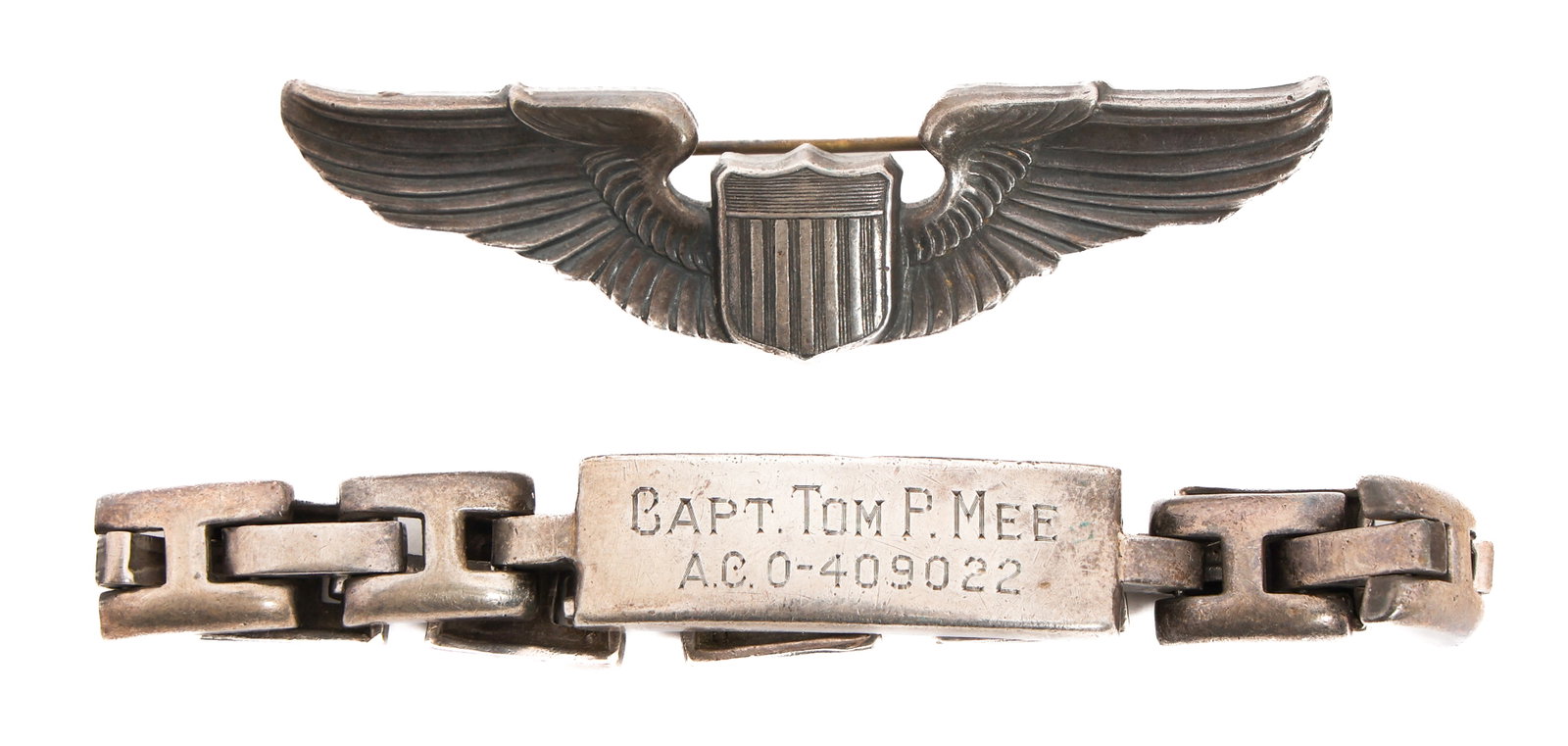 WWII USAAF NAMED PILOT WINGS & ID BRACELET: WWII USAAF NAMED PILOT WINGS & ID BRACELET WWII USAAF Pilot Wings and ID Bracelet. Named to Captain Tom P. Mee, O-409022. (1) 3" Sterling Pilot Wings. Engraved on the reverse. Dated 1942. (1) Sterling