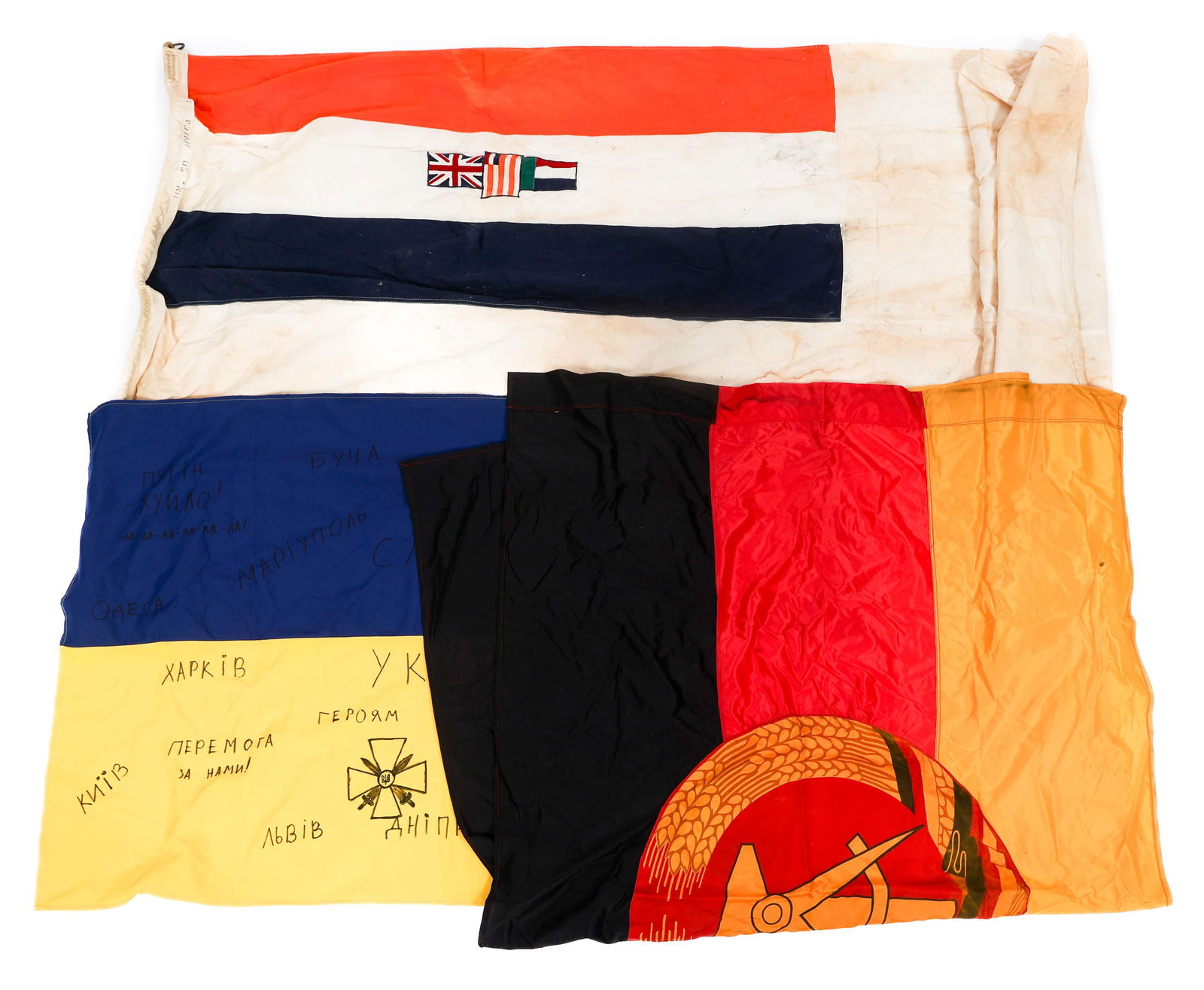 COLD WAR GERMAN, SOUTH AFRICAN & UKRAINIAN FLAGS: COLD WAR GERMAN, SOUTH AFRICAN & UKRAINIAN FLAGS Cold War East German, South African and Ukrainian Flags. All are multi-piece construction. Rope present on South African Flag. Size: 34" x 54" to 50" x