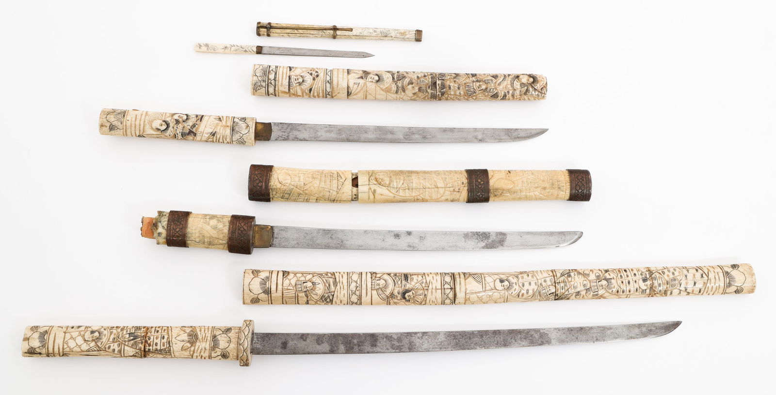 JAPANESE CARVED BONE WAKIZASHI & KOZUKA: JAPANESE CARVED BONE WAKIZASHI & KOZUKA Japanese Carved Bone Wakizashi and Kozuka. (3) Wakizashi. Single edged, curved blades. No marks visible. Carved bone Tsuka and Saya. (1) Kozuka. Single edged bl