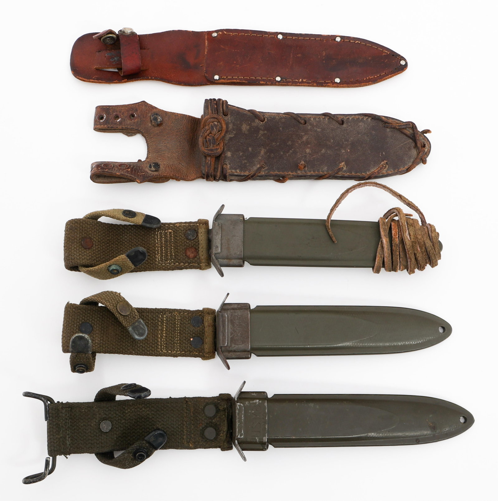 WWII US M8 SCABBARDS & CIVILIAN LEATHER SHEATH: WWII US M8 SCABBARDS & CIVILIAN LEATHER SHEATH WWII US M8 Scabbards & Civilian Leather Sheaths. (3) M8 Plastic Scabbards with Web Frogs. All are maker marked by B.M. Co. (2) Civilian leather Knife She