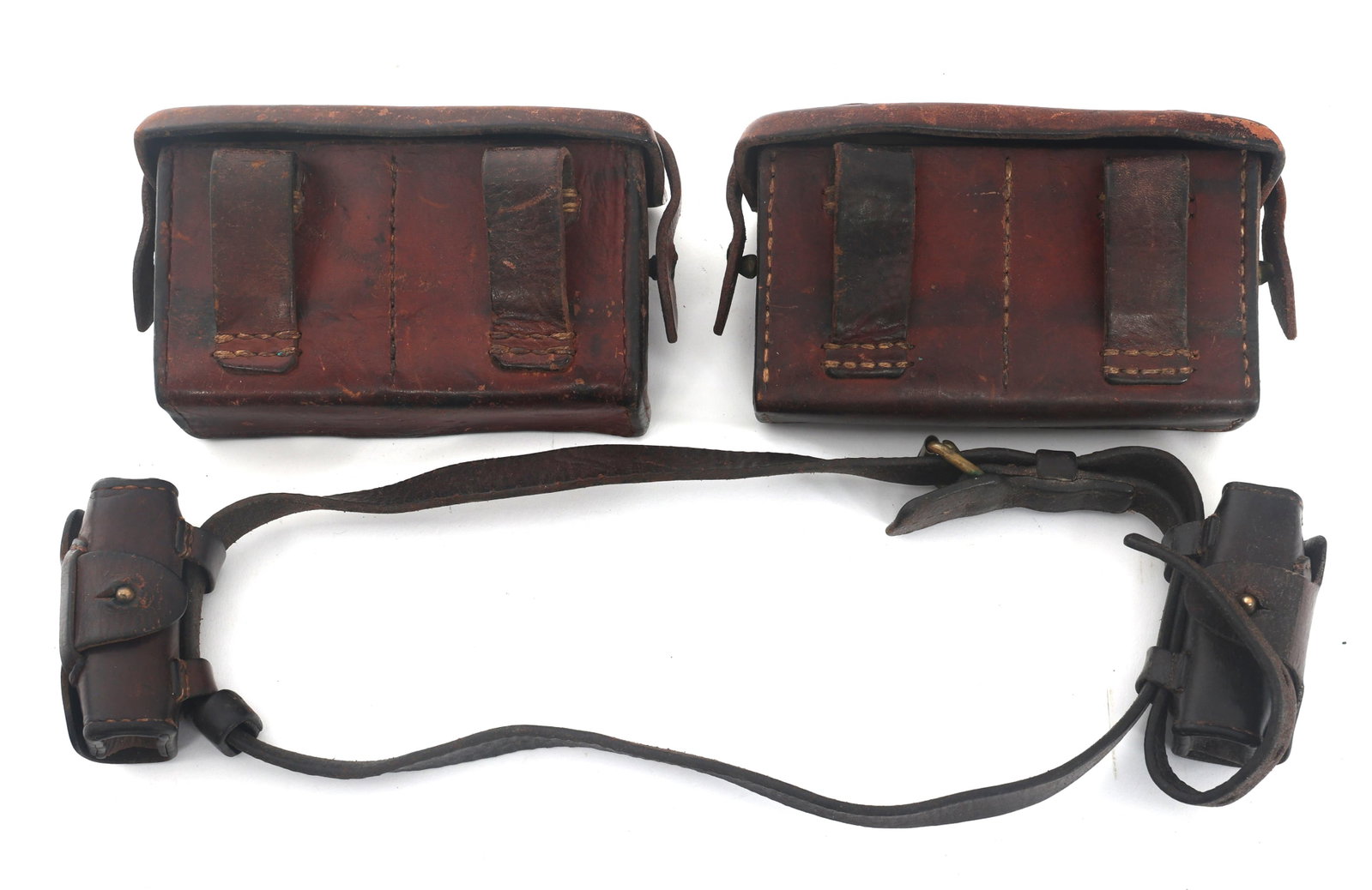 WWII JAPANESE AMMUNITION POUCHES: WWII JAPANESE AMMUNITION POUCHES WWII Japanese ammunition pouches. (2) WWII Japanese Arisaka front ammunition pouches with deactivated ammunition in stripper clips. (1) Japanese Officer's leather pist
