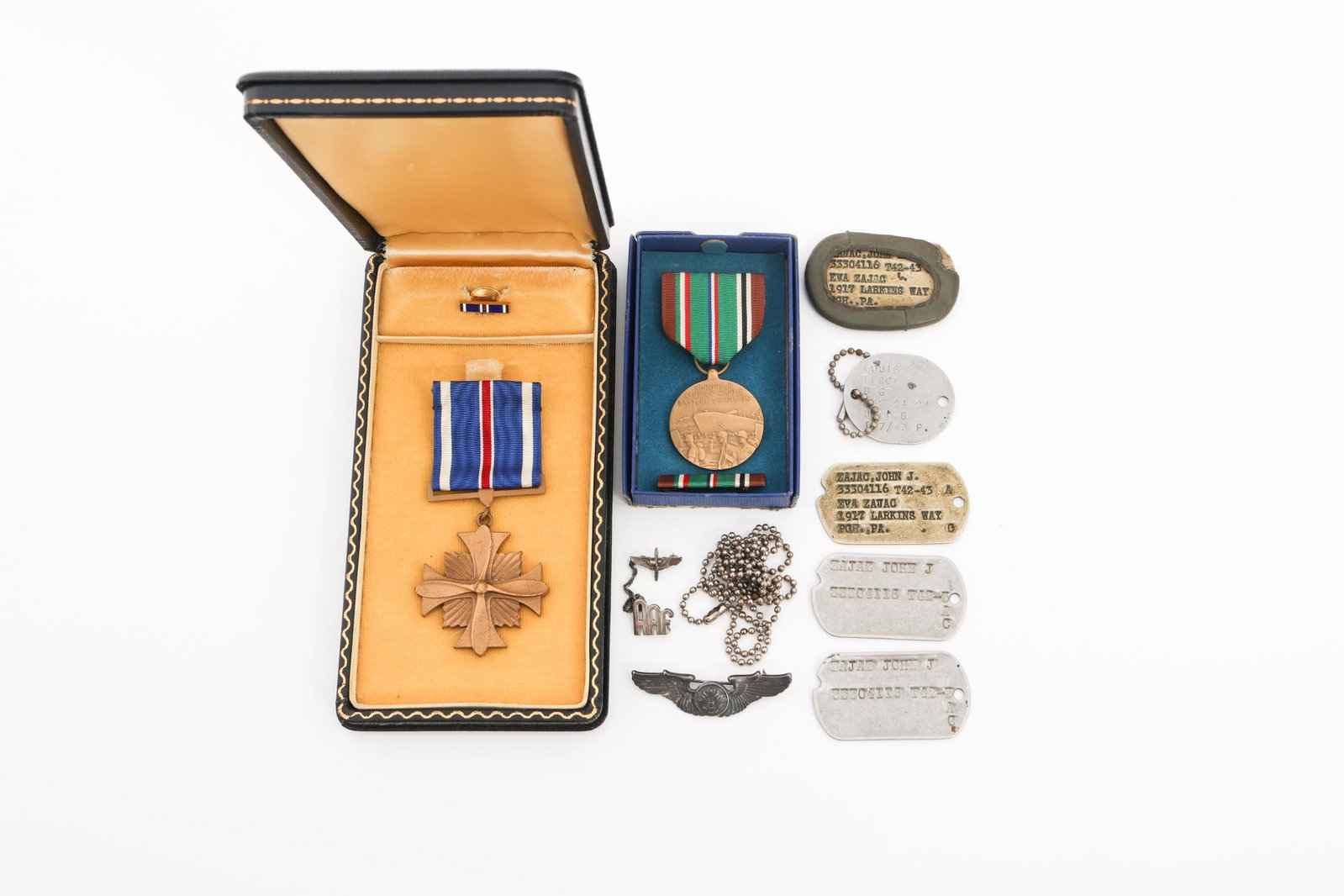 WWII USAAF DISTINGUISHED FLYING CROSS & DOG TAGS: WWII USAAF DISTINGUISHED FLYING CROSS & DOG TAGS WWII USAAF Distinguished Flying Cross, Army and Navy Dog tags. (1) DFC. Unnamed. Includes lapel pin and case. (1) USN Dog Tag. Named to Louis Eldon Deg