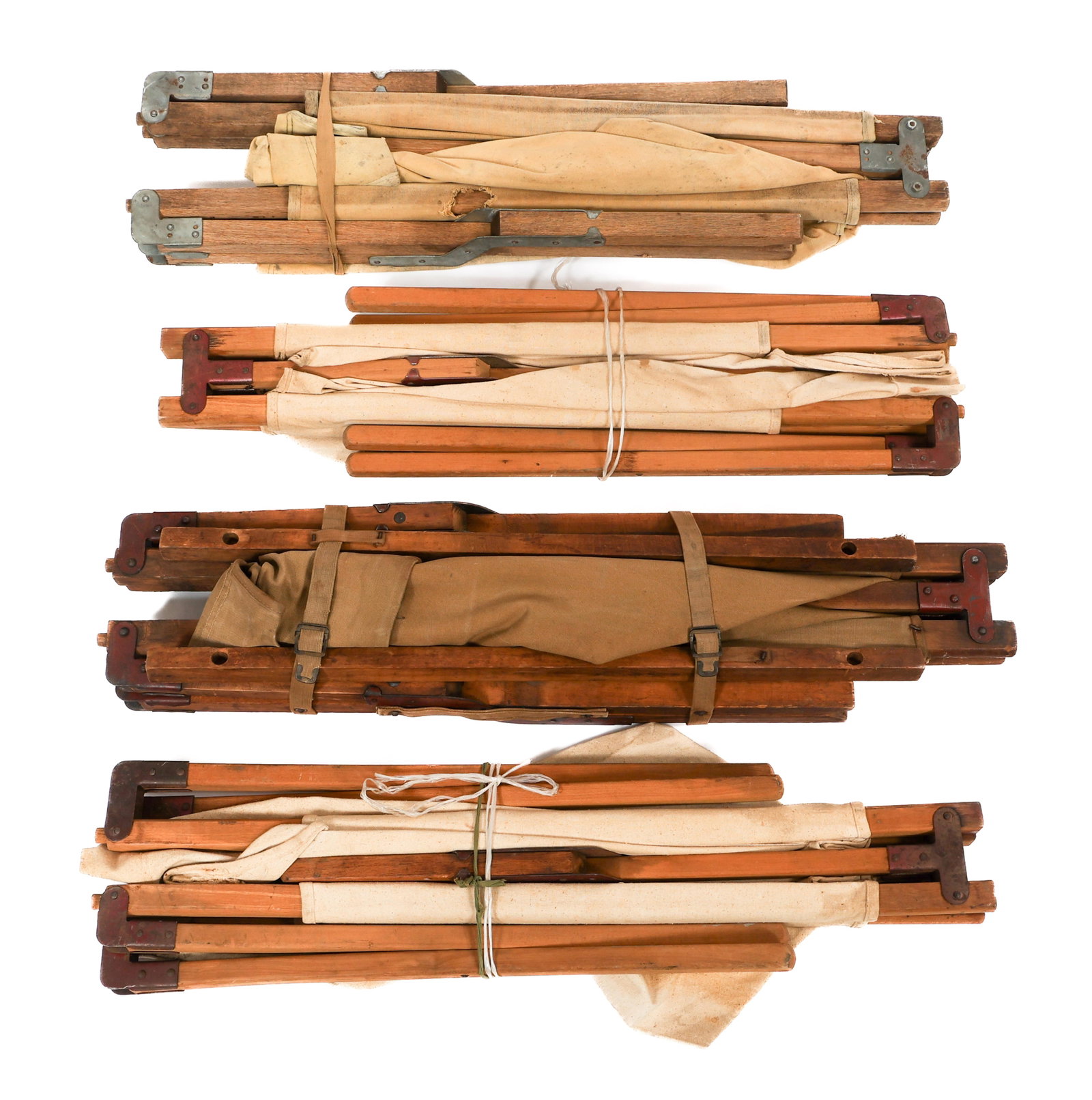 WWI - COLD WAR US ARMED FORCES COTS: WWI - COLD WAR US ARMED FORCES COTS WWI - Cold War US Armed Forces Cots. Wooden and canvas construction. Collapsed size: 35" x 9" x 5". Expanded size: 75" x 17" x 25 1/2". Weight: 60 lbs