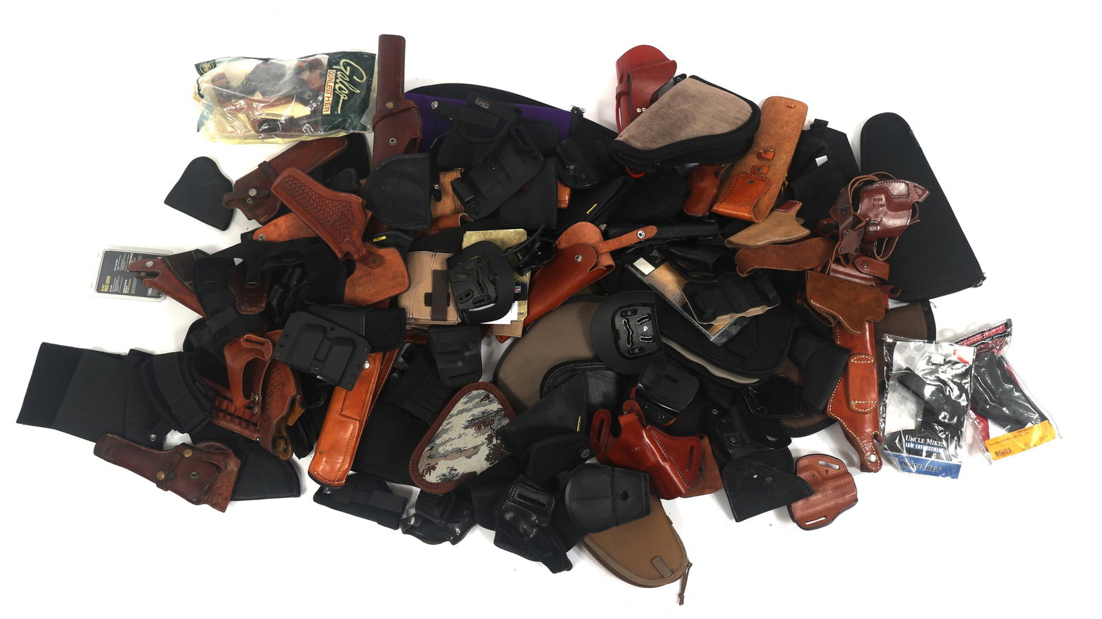 PISTOL AND REVOLVER HOLSTERS, BELT, AND POUCHES: PISTOL AND REVOLVER HOLSTERS, BELT, AND POUCHES Pistol and Revolver holsters, belts and pouches. Mixed brands and sizes. Brands include Bianchi, Uncle Mikes, Ace Case, Pole craft, Remora Safari Land a