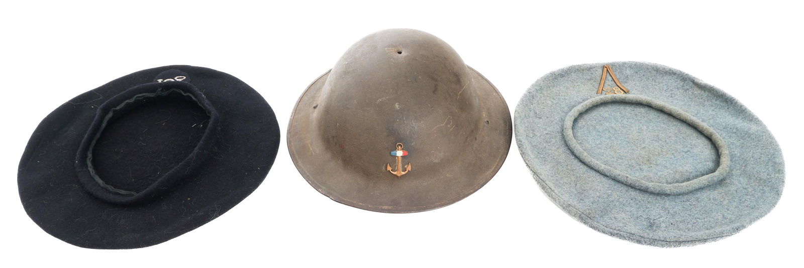 WWI FRENCH CHASSEUR ALPIN & COLONIAL INF. HELMET: WWI FRENCH CHASSEUR ALPIN & COLONIAL INF. HELMET WWI French Headgear. (1) WWI French Chasseur a Pied beret, dark blue wool with silver thread embroidered insignia. No dates or stamps. (1) WWI 28th Bat