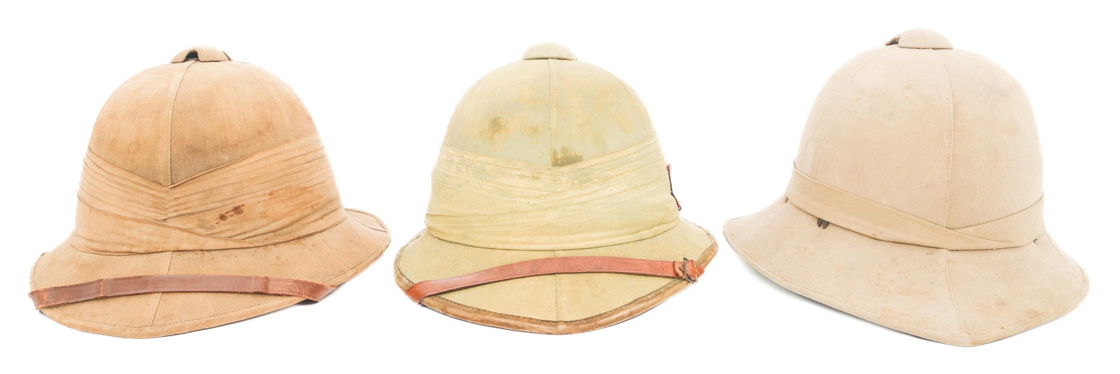 WWI - WWII BRITISH WOLSELEY PATTERN PITH HELMETS: WWI - WWII BRITISH WOLSELEY PATTERN PITH HELMETS WWI - WWII British Wolseley Pattern Pith Helmets. (3) Khaki twill covered cork construction pith helmets. One has a Royal Artillery flash on one side. 