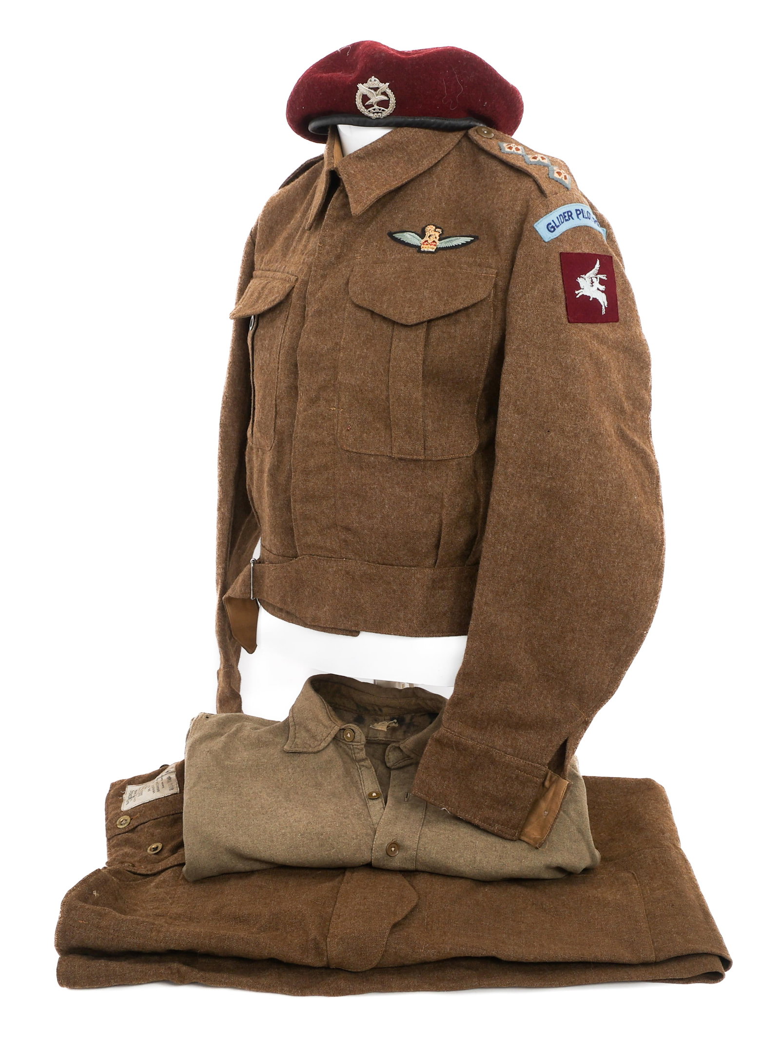 WWII UK GLIDER CAPTAIN BATTLE DRESS UNIFORM: WWII UK GLIDER CAPTAIN BATTLE DRESS UNIFORM WWII British Glider Captain's Battle Dress Uniform. (1) Maroon Beret. Glider pilot front badge. Maker marked by Kangol Wear and dated 1945 on the inside. (1