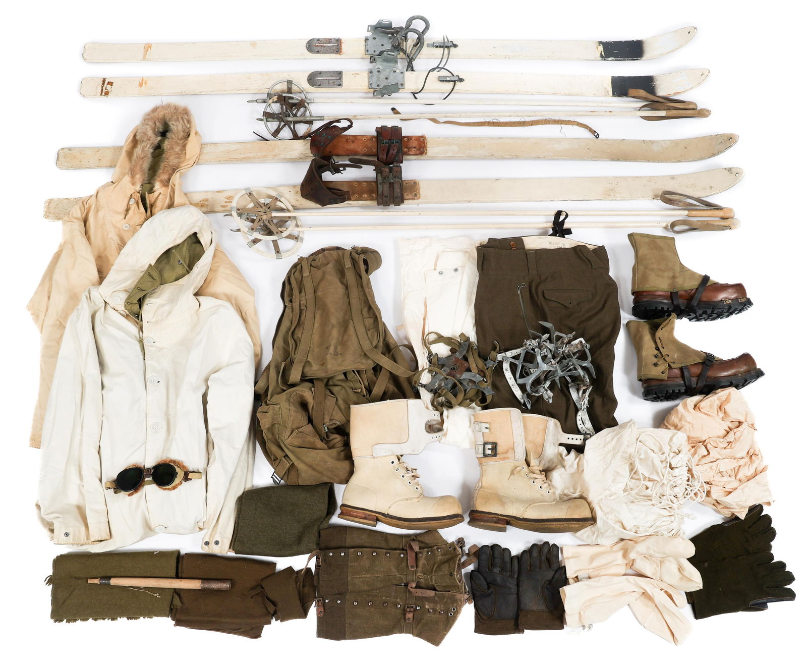WWII US MOUNTAIN TROOP SKIS & WINTER UNIFORM ITEMS: WWII US MOUNTAIN TROOP SKIS & WINTER UNIFORM ITEMS WWII US Army Mountain Troop Skis and Winter Uniform Items. (2) Ski Sets. Poles included. Various dates and stamps present. (2) Winter Snow Parkas. (1