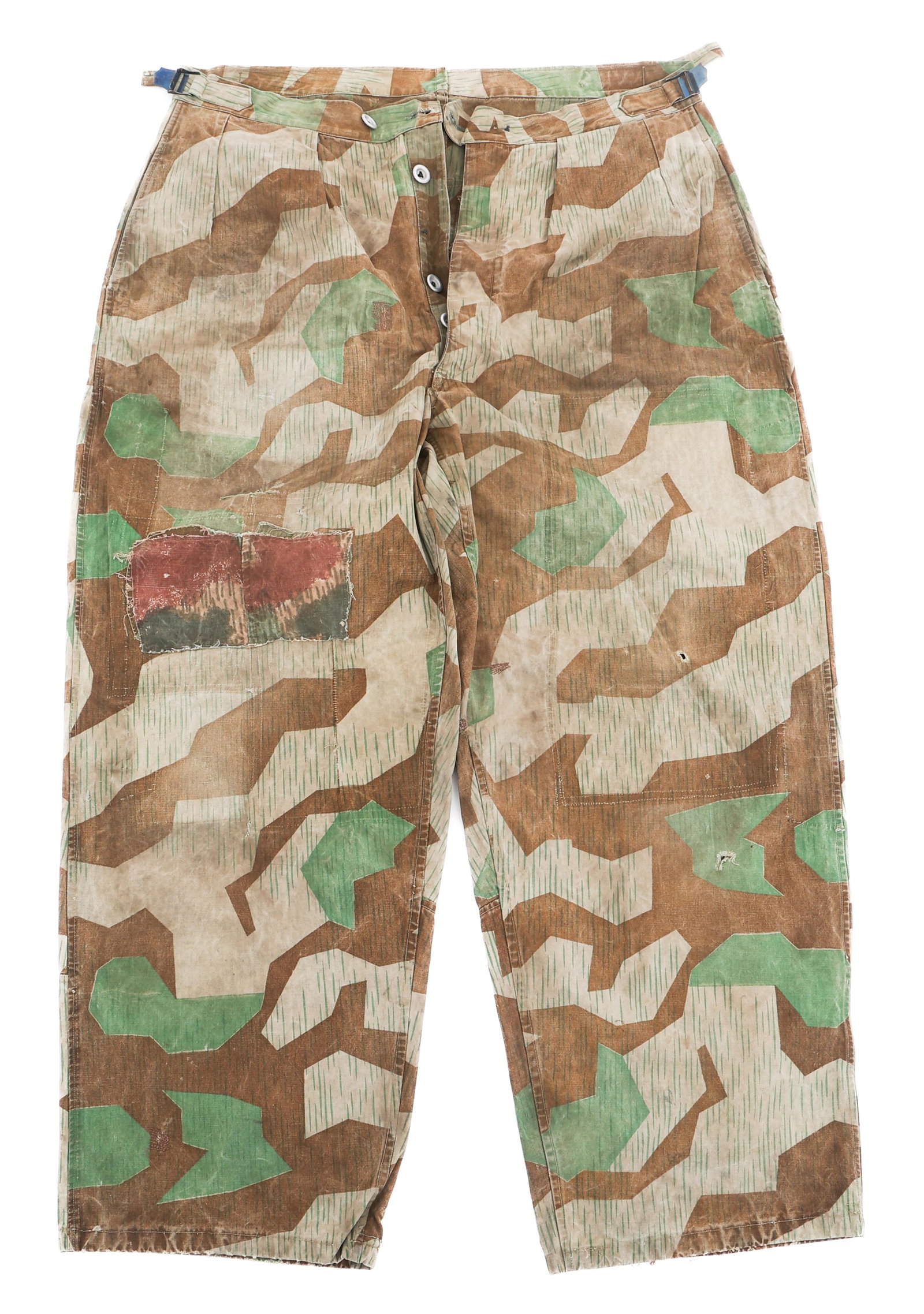 WWII GERMAN MODIFIED ZELTBAHN SPLINTER CAMO PANTS: WWII GERMAN MODIFIED ZELTBAHN SPLINTER CAMO PANTS WWII German Modified Zeltbahn Splinter Camouflage Pants. Zeltbahn camouflage with blued steel buttons. Stumpfmunster patches on the knee and left rear
