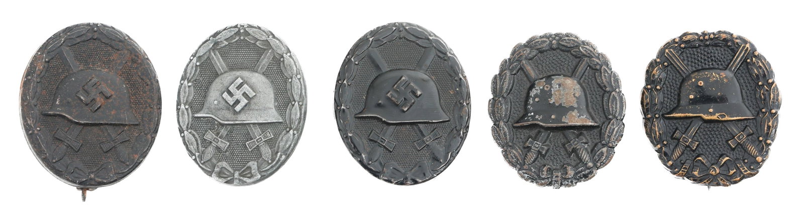 WWI - WWII GERMAN SILVER & BLACK WOUND BADGES: WWI - WWII GERMAN SILVER & BLACK WOUND BADGES Five WWI - WWII German Silver and Black Wound Badges. (1) Silver Wound Badge. Marked on the leg, illegible. (2) WWI Black Wound Badge. No visible marks. (