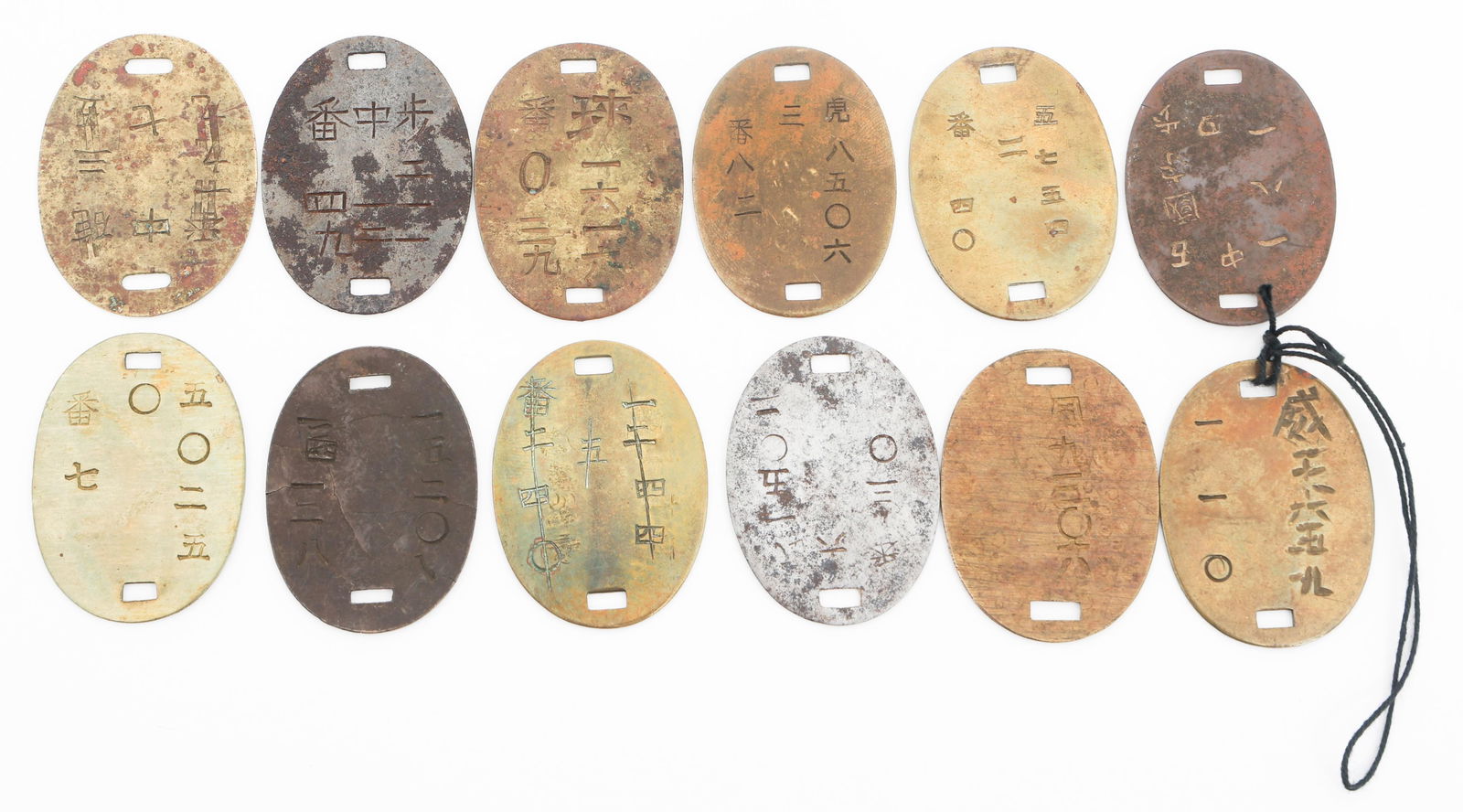 IMPERIAL JAPANESE ARMY DOG TAGS: IMPERIAL JAPANESE ARMY DOG TAGS Imperial Japanese Army Dog Tags. Brass and copper construction. Various Kanji stamps present. One with string present.