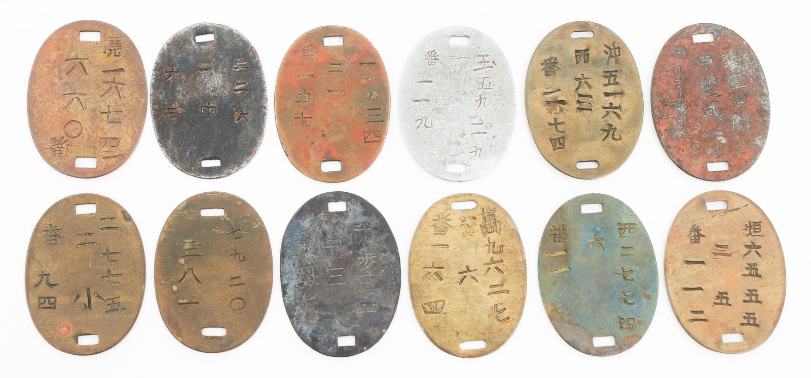 IMPERIAL JAPANESE ARMY DOG TAGS: IMPERIAL JAPANESE ARMY DOG TAGS Imperial Japanese Army Dog Tags. Brass, alloy and copper construction. Various Kanji stamps present.