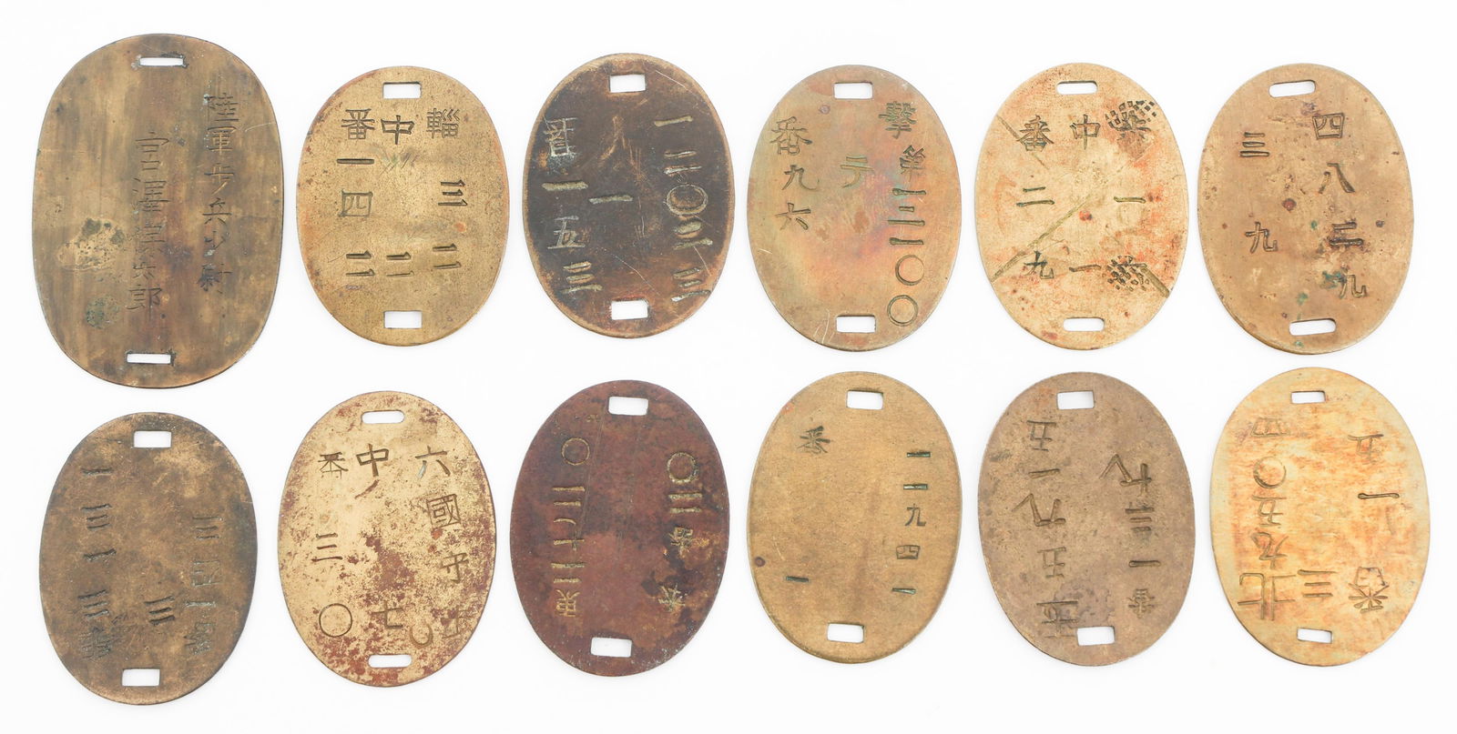 IMPERIAL JAPANESE ARMY DOG TAGS: IMPERIAL JAPANESE ARMY DOG TAGS Imperial Japanese Army Dog Tags. Brass and copper construction. Various Kanji stamps present.