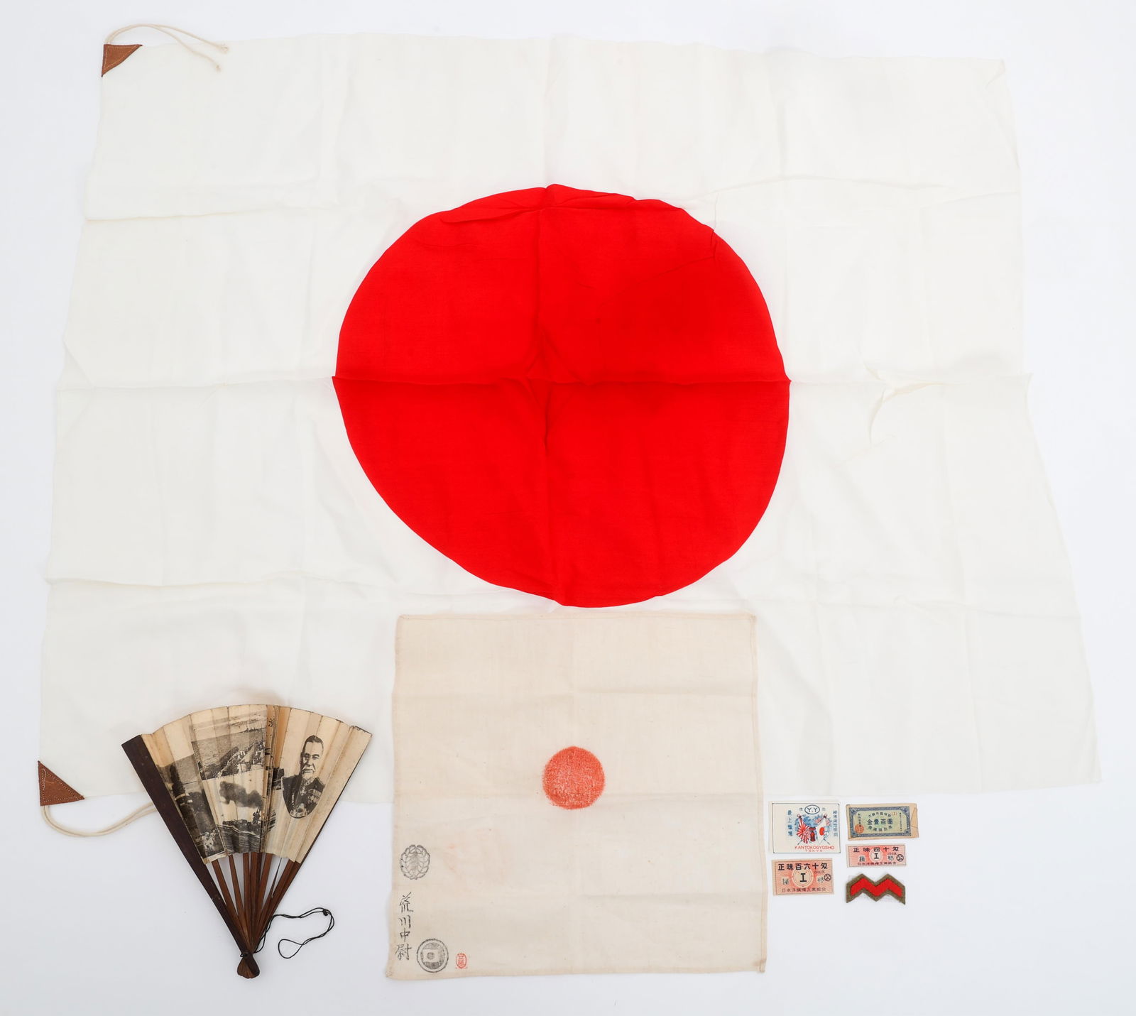 WWII IMPERIAL JAPANESE NATIONAL FLAGS: WWII IMPERIAL JAPANESE NATIONAL FLAGS WWII Imperial Japanese National Flags, fan, product labels, and Chinese treasury note. (1) Flag. Double sided, single-piece cotton/linen construction with printed