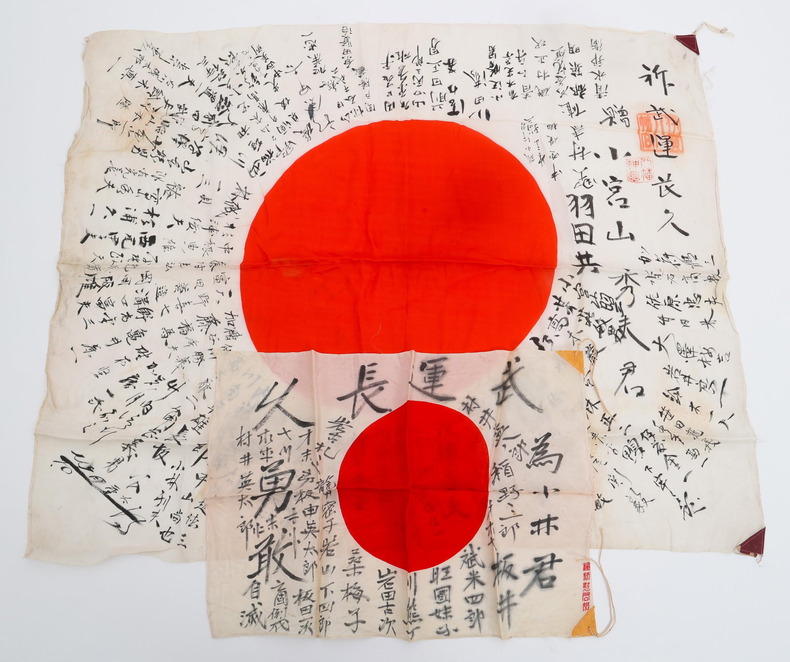 WWII IMPERIAL JAPANESE YOSEGAKI HINOMARU FLAGS: WWII IMPERIAL JAPANESE YOSEGAKI HINOMARU FLAGS Two WWII Imperial Japanese Yosegaki Hinomaru Flags. Double sided, single-piece silk construction with printed emblems and handwritten kanji characters. C