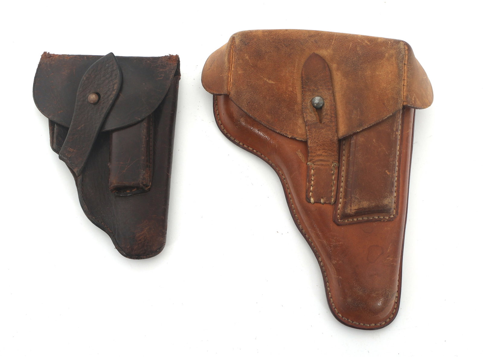 WALTHER PISTOL HOLSTERS: WALTHER PISTOL HOLSTERS Two Walther pistol holsters. Light brown Walther PP holster. 35B453531 - Shana written on inside flap. Back stamped Wersa - 1941 - Munchen. Contains one magazine. Dark brown Wa