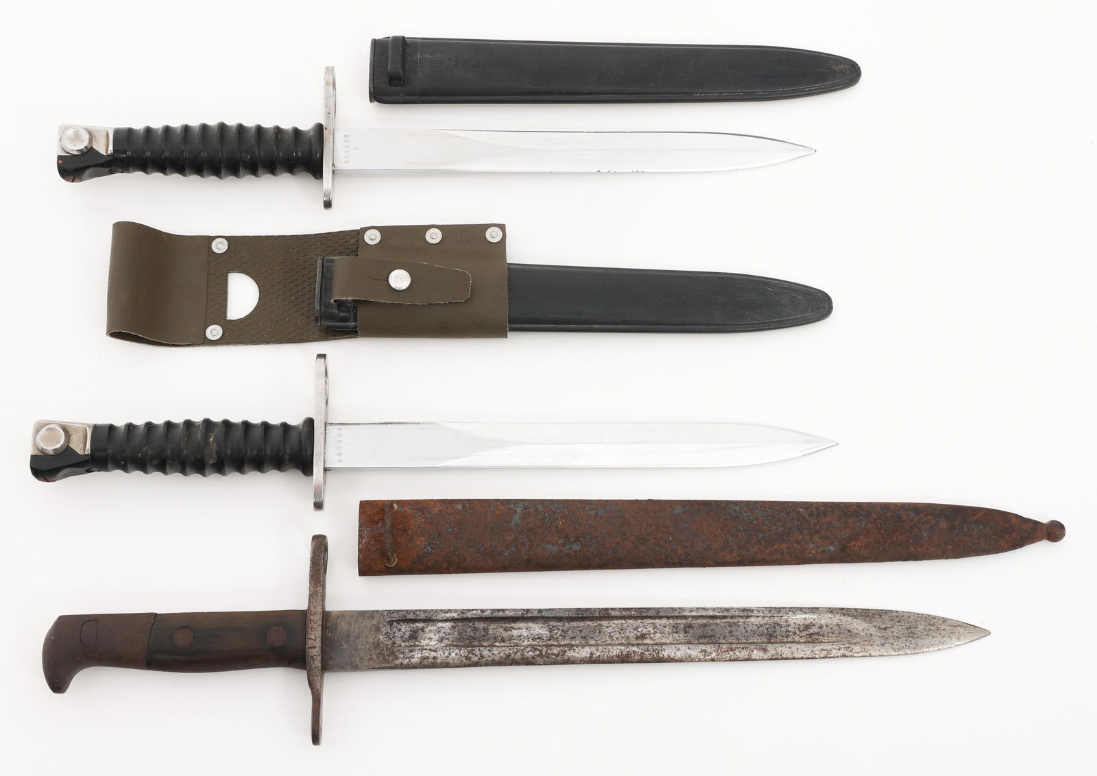 SWISS M1899 & M1957 BAYONETS: SWISS M1899 & M1957 BAYONETS Swiss M1899 & M1957 Bayonets. (1) M1899. No visible maker marks. Steel scabbard. (2) M1957. Maker marked by Waffenfabrik Bern. Plastic scabbards. One has a plastic frog. B