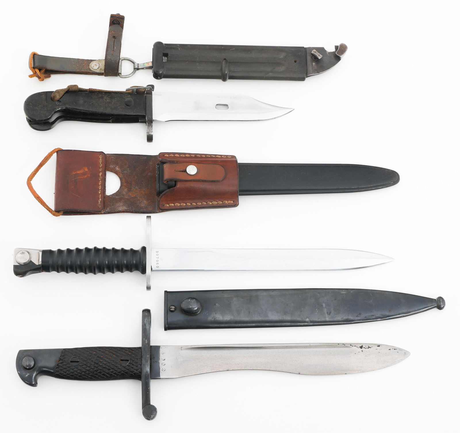 WWII - COLD WAR SPANISH, SWISS & GERMAN BAYONETS: WWII - COLD WAR SPANISH, SWISS & GERMAN BAYONETS WWII - Cold War Spanish, Swiss, & East German Bayonets. (1) Spanish M1941. Maker marked by Toledo Arms Factory. Steel scabbard. (1) Swiss M1957. Maker