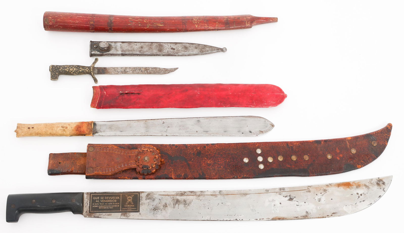 THEATER MADE & CIVILIAN KNIVES & MACHETES: THEATER MADE & CIVILIAN KNIVES & MACHETES Theater Made and Civilian Knives and Machetes. (1) Corona Machete. Leather sheath. (1) Leaf Blade Machete. Scabbard. (1) Theater Made Knife. Brass Handle. Bay