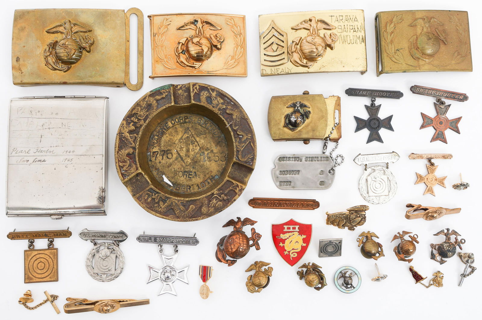 WWII - KOREAN WAR USMC INSIGNIA & PERSONAL ITEMS: WWII - KOREAN WAR USMC INSIGNIA & PERSONAL ITEMS WWII - Korean War USMC Insignia and Personal Items. Includes EGAs, Belt Buckles, Tie Clasp, Marksman Badges, Pins, Mini Medal, Cigarette Case, Commemor