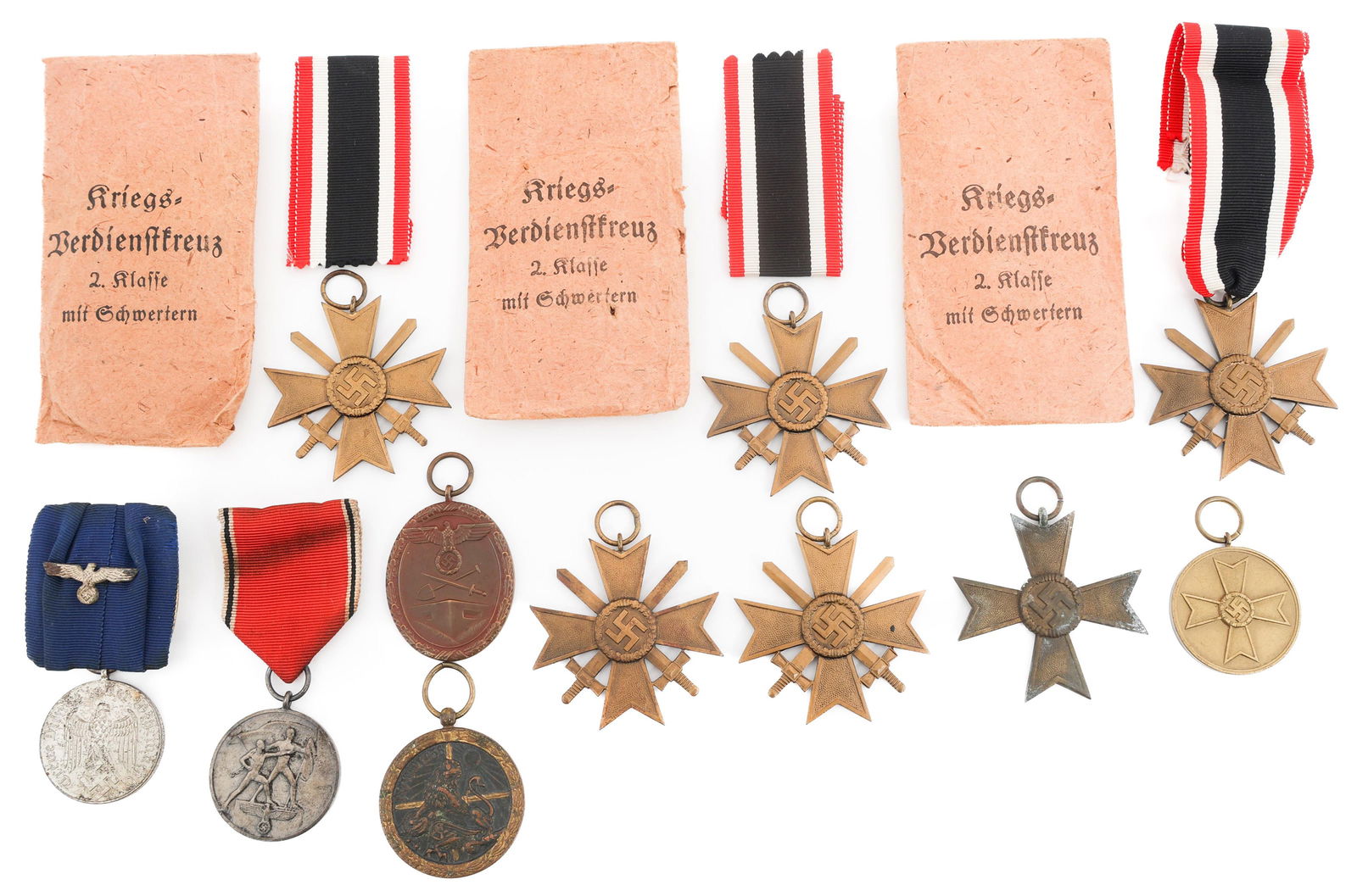 WWII GERMAN MERIT CROSS & SERVICE MEDALS: WWII GERMAN MERIT CROSS & SERVICE MEDALS WWII German Merit Cross and Service Medals. (5) Merit Cross with Swords. Three with ribbons and award packages present. (1) Merit Cross. (1) Entry in Austria M
