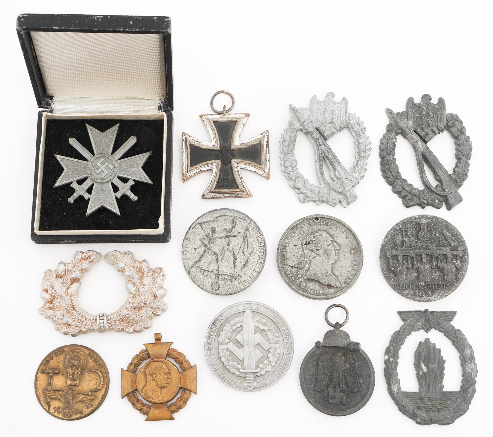 WWI - WWII GERMAN IRON CROSS, MEDALS, & BADGES: WWI - WWII GERMAN IRON CROSS, MEDALS, & BADGES WWI - WWII German Iron Cross, Medals, and Tinnies. (1) WWII German Iron Cross 2nd Class. (1) WWII German War Merit Cross pinback medal in Original Box. (