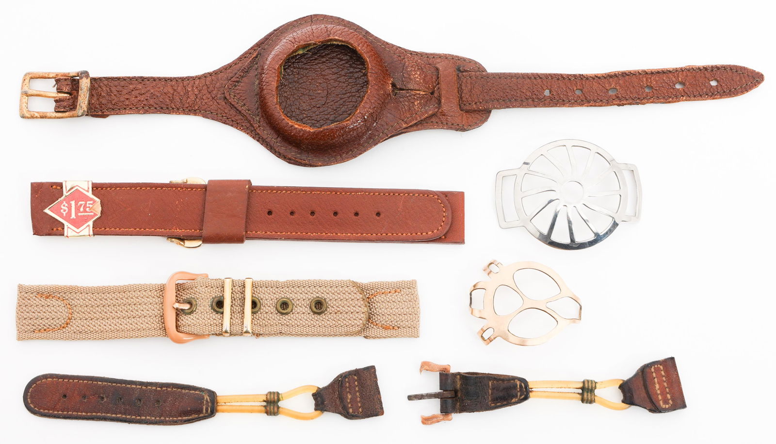 WWI US ARMY TRENCH WATCH STRAPS & SHRAPNEL GUARDS: WWI US ARMY TRENCH WATCH STRAPS & SHRAPNEL GUARDS WWI US Army Trench Watch Straps and Shrapnel Guards. (2) Leather Straps. (2) Leather Strap Parts. (1) Canvas Strap. (2) Shrapnel guards. One is dated,