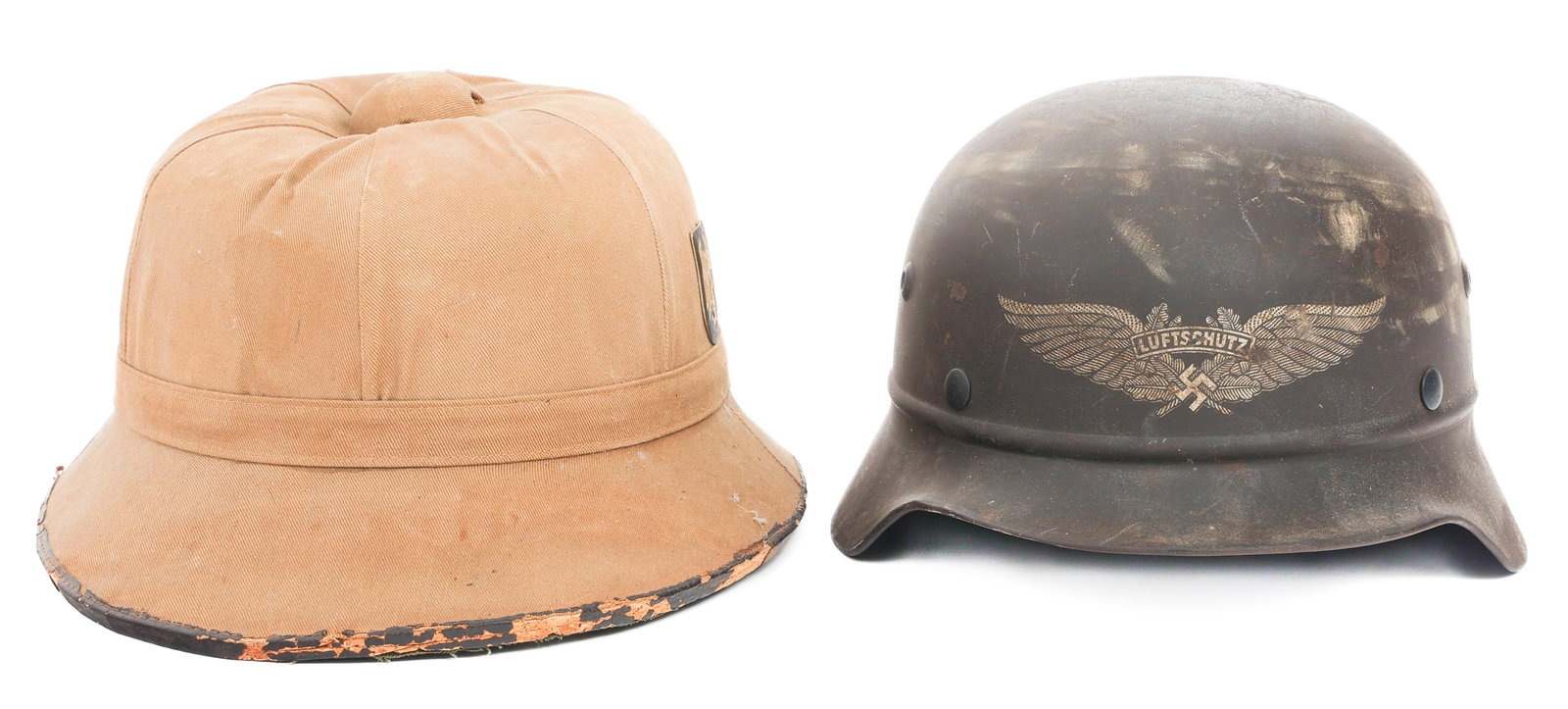 WWII GERMAN M34 LUFTSCHUTZ & TROPICAL PITH HELMETS: WWII GERMAN M34 LUFTSCHUTZ & TROPICAL PITH HELMETS (1) WWII German M34 Luftschutz Helmet Shell, 90% Front decal, no liner or chinstrap. Rivets present. (1) WWII German 1st pattern tropical helmet. Kha