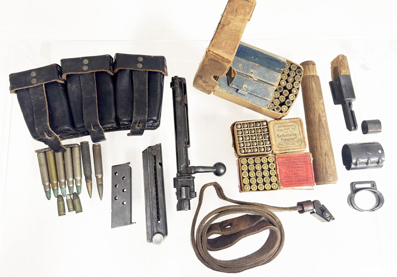 WWII FIREARM PARTS AND PISTOL & RIFLE AMMUNITION: WWII FIREARM PARTS AND PISTOL & RIFLE AMMUNITION WWII Firearm Parts, and Pistol & Rifle Ammunition. 50 rounds 7.65mm pistol ammunition in boxed. 78 rounds 9mm ammunition in shipping box with stamps. S