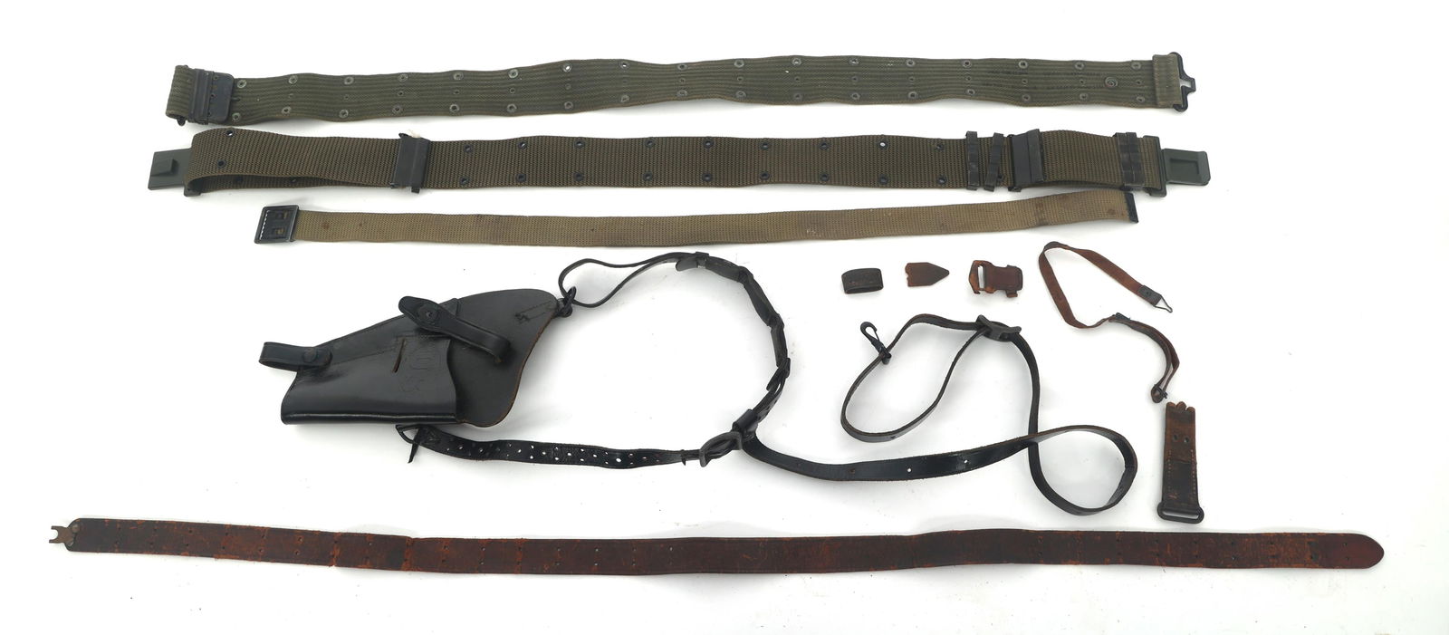 BELTS, SLING, AND HOLSTER: BELTS, SLING, AND HOLSTER Belts, sling and holster. Holster stamped US, MRT and Bucheimer. Note: Shipping & Payment Shipping: In-house shipping is available. We remain committed to providing the