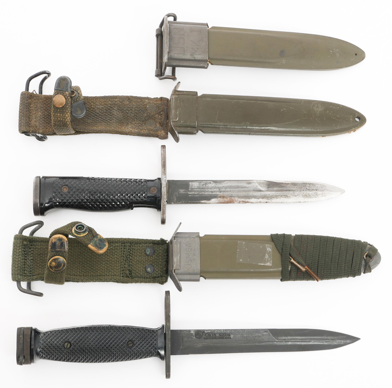 COLD WAR US M6 & M7 BAYONETS WITH SCABBARDS: COLD WAR US M6 & M7 BAYONETS WITH SCABBARDS Cold War US M6 and M7 Bayonets with Scabbards. (1) M6 Bayonet. Single edged blade. Maker marked by MILPAR Co and marked M6 under the guard. Steel hilt with