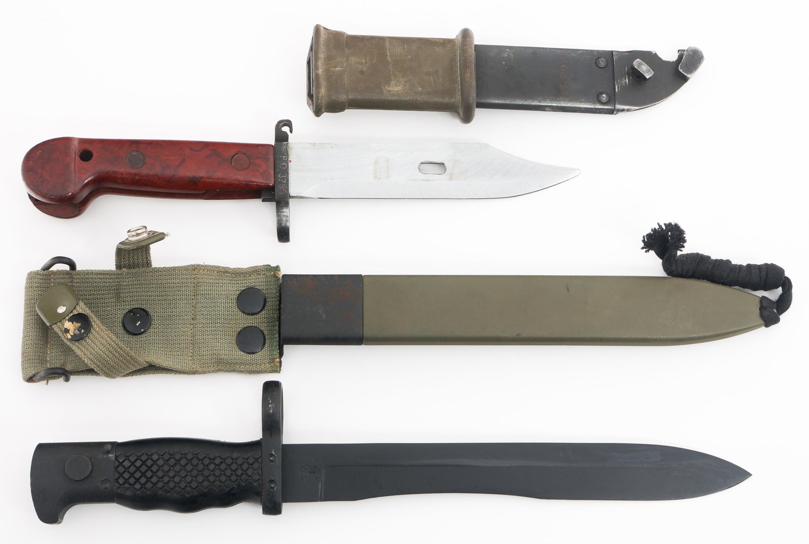 COLD WAR SPANISH M1964 & AKM TYPE 1 BAYONETS: COLD WAR SPANISH M1964 & AKM TYPE 1 BAYONETS Cold War Spanish M1964 & AKM Type 1 Bayonets. (1) AKM Type 1 Bayonet. Serial numbered PO356 on the guard. Metal scabbard with matching serial numbers. (1)