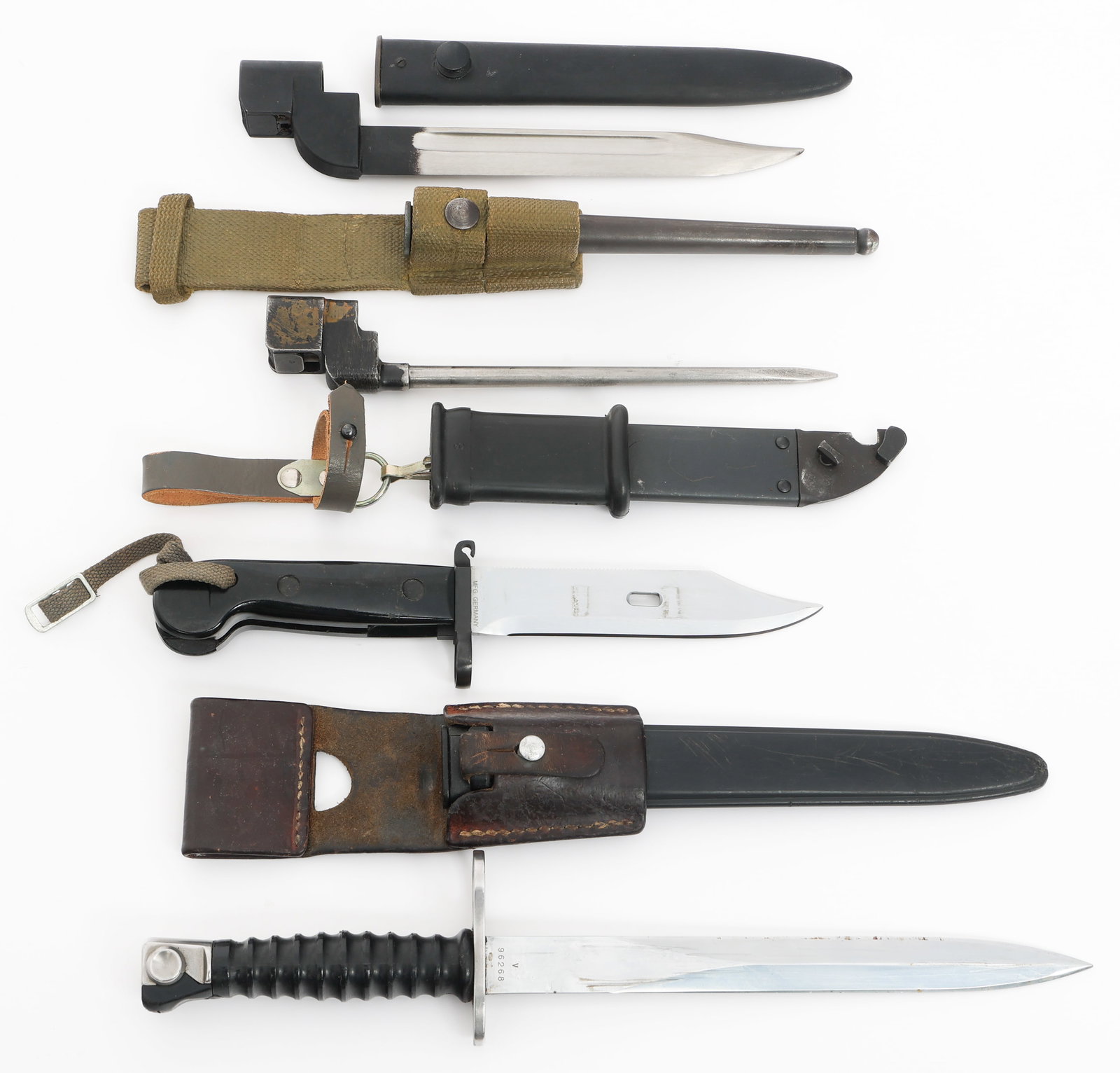 COLD WAR EAST GERMAN, SWISS & UK BAYONETS: COLD WAR EAST GERMAN, SWISS & UK BAYONETS Cold War East German, Swiss and UK Bayonets. (1) East German AKM Type 1. Single edged, bright blade. Marked Mfg Germany on the ricasso. Steel hilt with compos