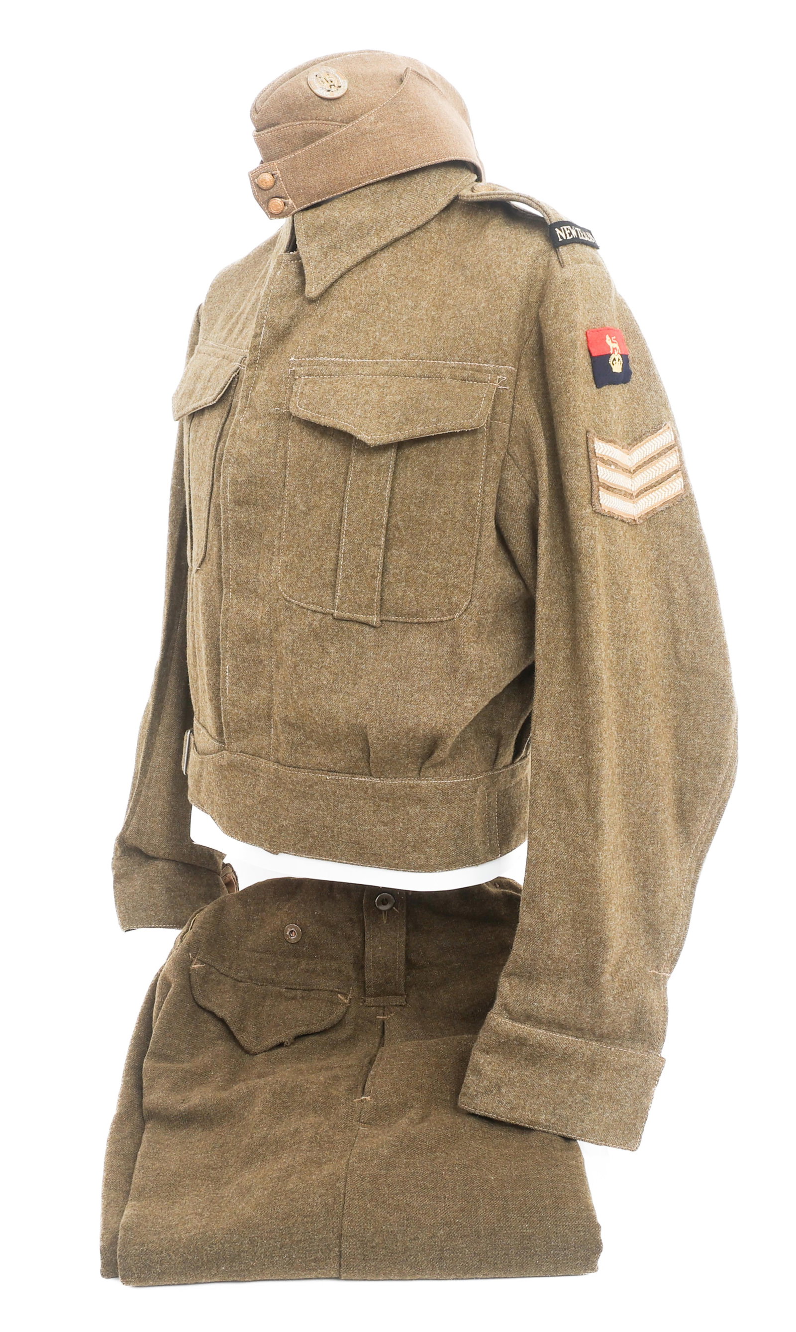 WWII NEW ZEALAND 15th AUCKLAND REGT BATTLE DRESS: WWII NEW ZEALAND 15th AUCKLAND REGT BATTLE DRESS WWII New Zealand 15th North Auckland Regiment Sergeant 1944 dated Battle Dress Uniform. (1) Wool Overseas Cap. 15th North Auckland cap badge. New Zeala