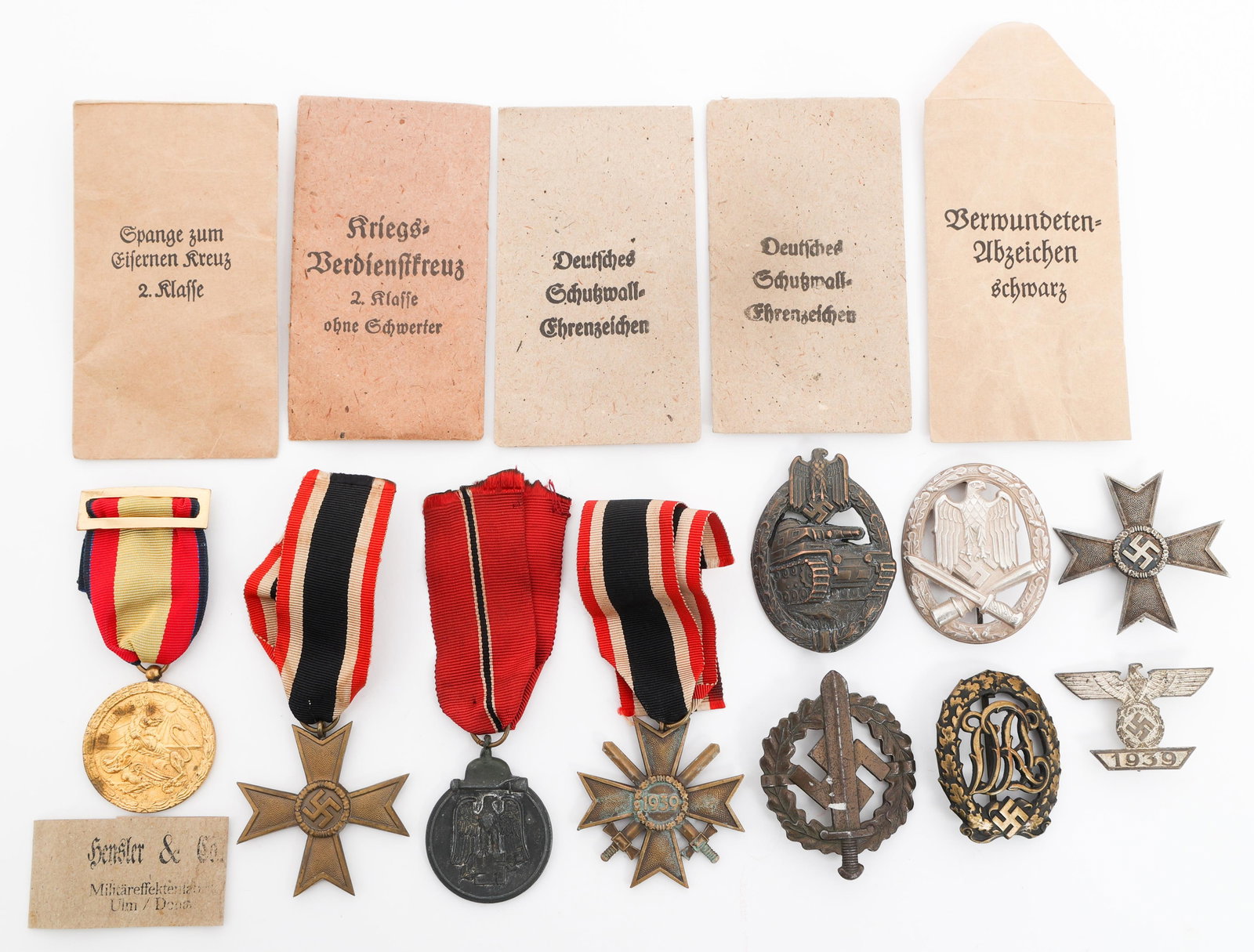 WWII GERMAN MERIT CROSS, BADGES, AND MEDALS: WWII GERMAN MERIT CROSS, BADGES, AND MEDALS WWII German War Merit Cross, Badges and Medals. (1) War Merit Cross 1st Class, stamped 4. (2) War Merit Cross, one with swords, one without. (1) 1939 clasp 