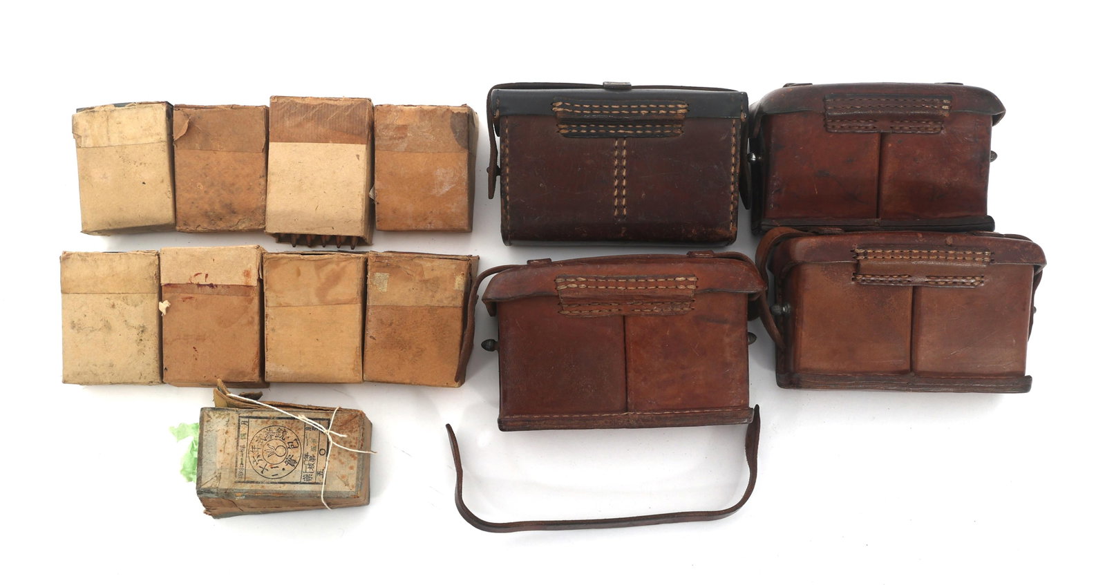 WWII JAPANESE AMMUNITION POUCHES & AMMUNITION: WWII JAPANESE AMMUNITION POUCHES & AMMUNITION WWII Japanese front ammunition pouches and ammunition. Four leather ammunition pouches. Three boxes of Type 38 6.5mm caliber rifle ammunition. Two boxes o
