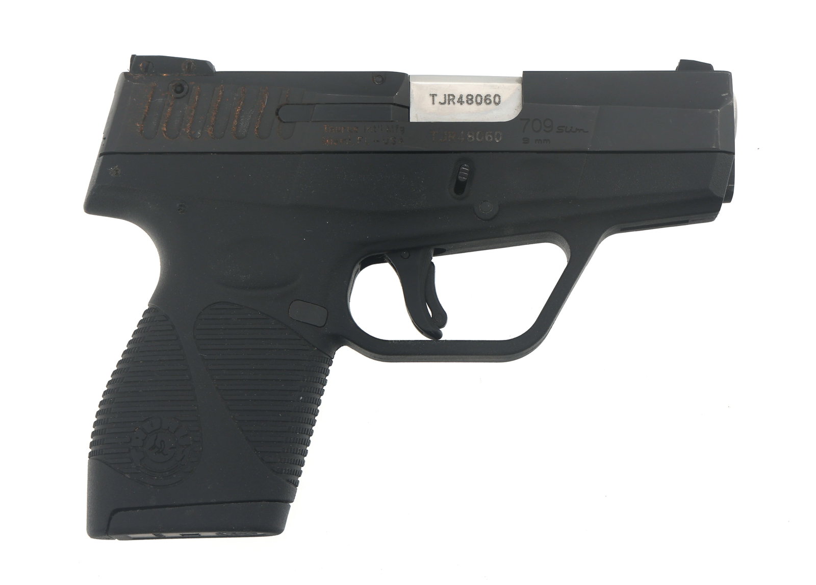 TAURUS MODEL 709 SLIM 9mm CALIBER SEMI AUTO PISTOL: TAURUS MODEL 709 SLIM 9mm CALIBER SEMI AUTO PISTOL Taurus Model 709 Slim 9x19mm caliber semi automatic pistol. Import stamped Taurus. Matte black finish. Fixed sights. Polymer frame with textured grip