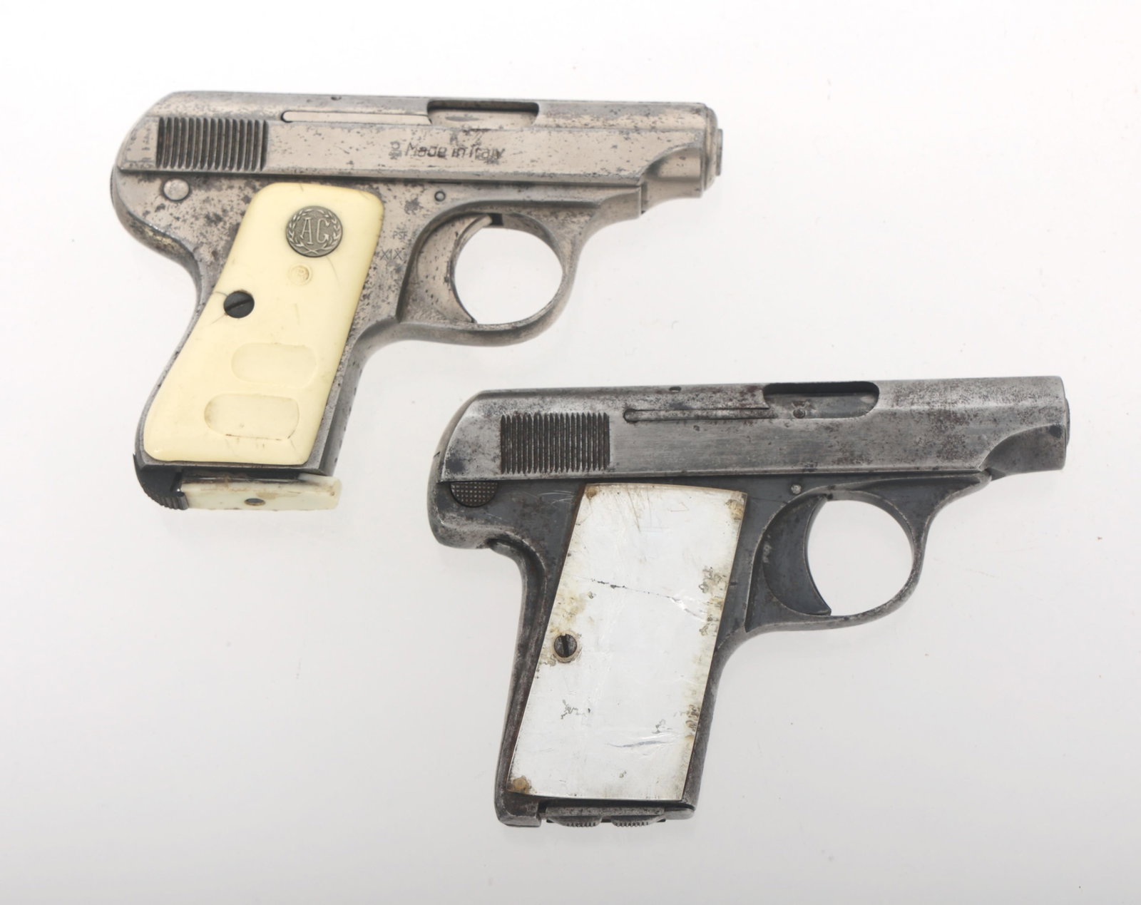 GALESI- BRESCIA 6.35mm CALIBER PISTOLS: GALESI- BRESCIA 6.35mm CALIBER PISTOLS Two Galesi-Brescia 6.35mm caliber semi automatic pistols. A) Model 504. Silver toned finish. White grips. One magazine with white base. B) Model 1923. Blued fini