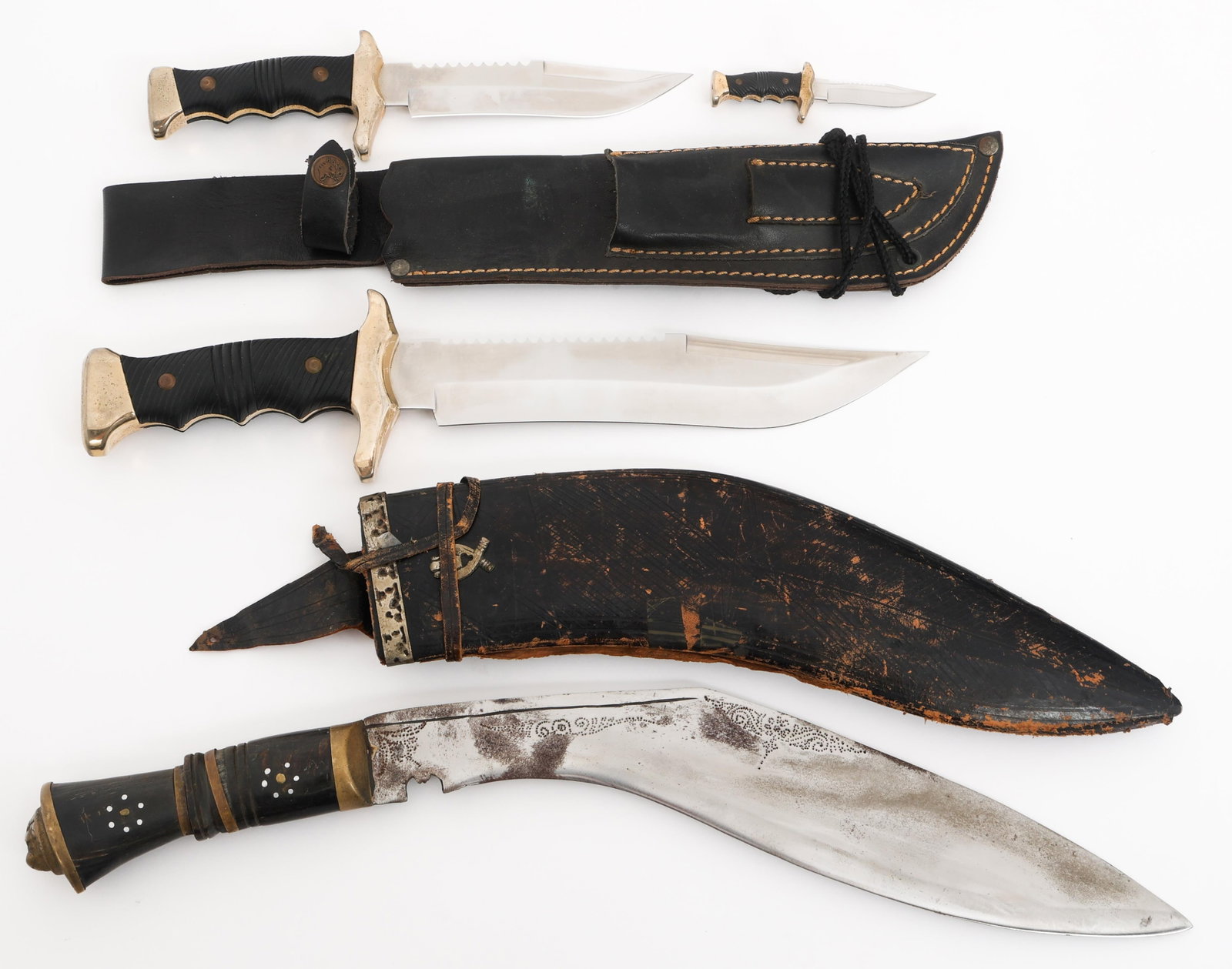 GURKHA KUKRI & HALCON BOWIE KNIVES: GURKHA KUKRI & HALCON BOWIE KNIVES Modern Gurkha Kukri and Halcon Bowie Knives. (1) Kukri Knife. Single edged, curved blade with fuller. Floral etchings near the spine. Horn handle. Leather wrapped