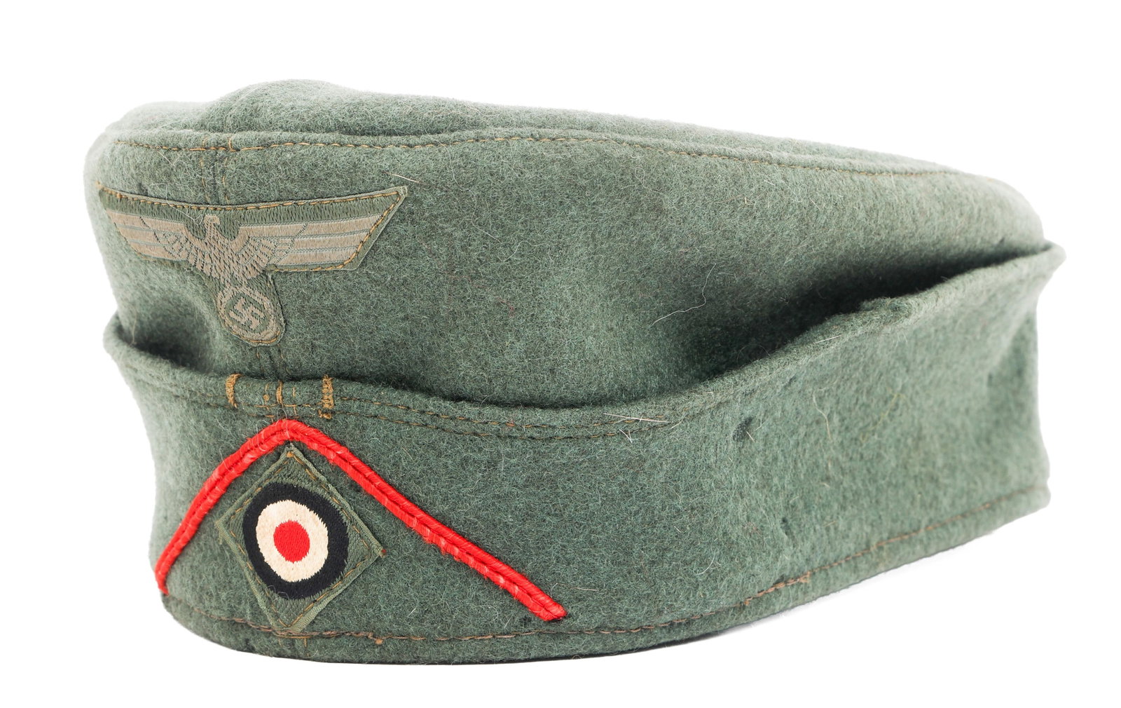 WWII GERMAN HEER M38 GARRISON CAP: WWII GERMAN HEER M38 GARRISON CAP WWII German Heer M38 Harrison Cap. Feldgrau wool with Artillery V shaped piping, Heer eagle patch and national cockade patch. No visible maker marks. Size: 67
