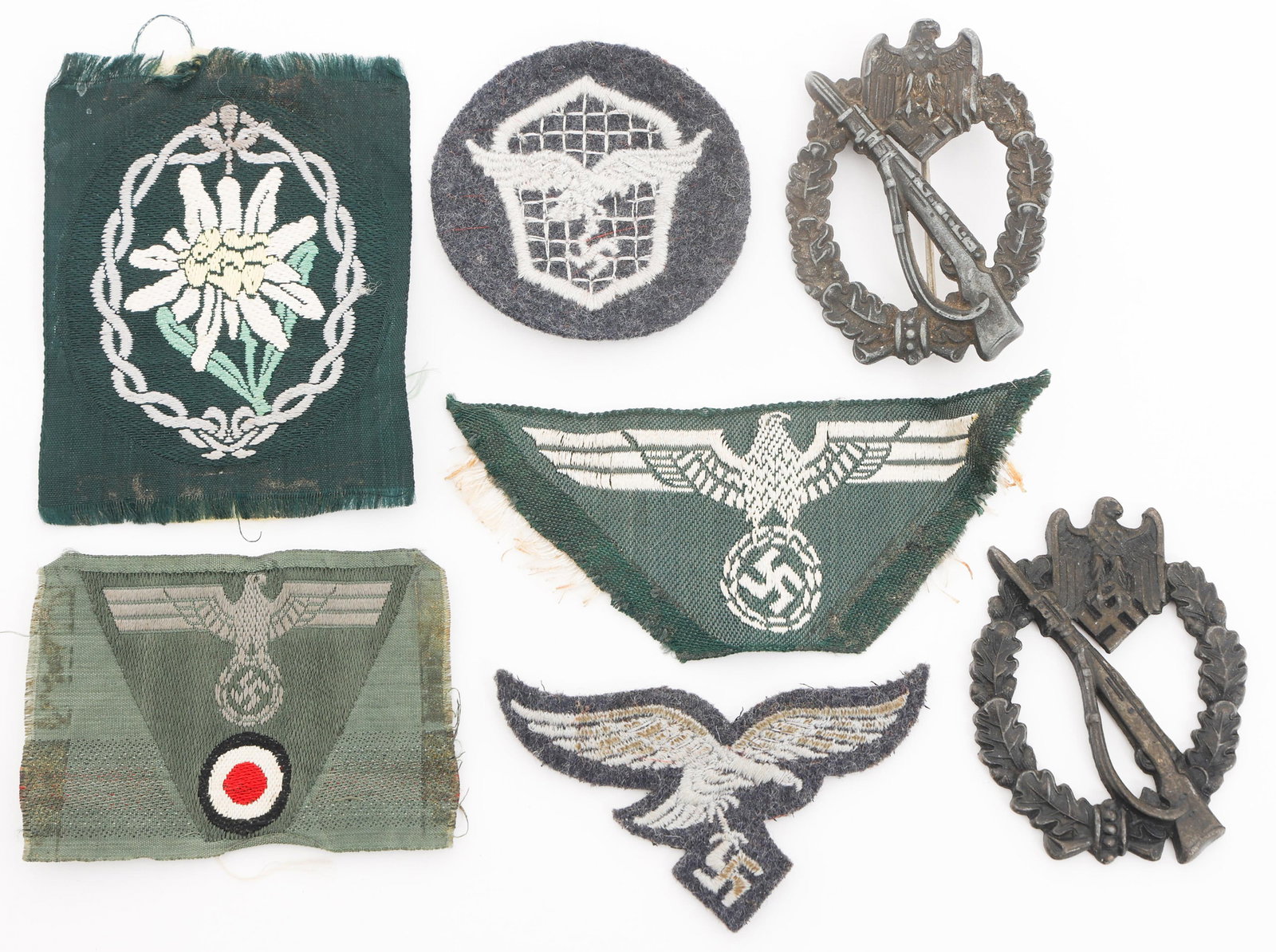 WWII GERMAN HEER & LUFTWAFFE BADGES & INSIGNIA: WWII GERMAN HEER & LUFTWAFFE BADGES & INSIGNIA WWII German Heer and Luftwaffe Badges and Insignia. (2) Combat Infantry Badges. One marked by GR & Co. (1) Heer Bevo Trapezoid. (1) Bevo Heer Eagle. (1) 