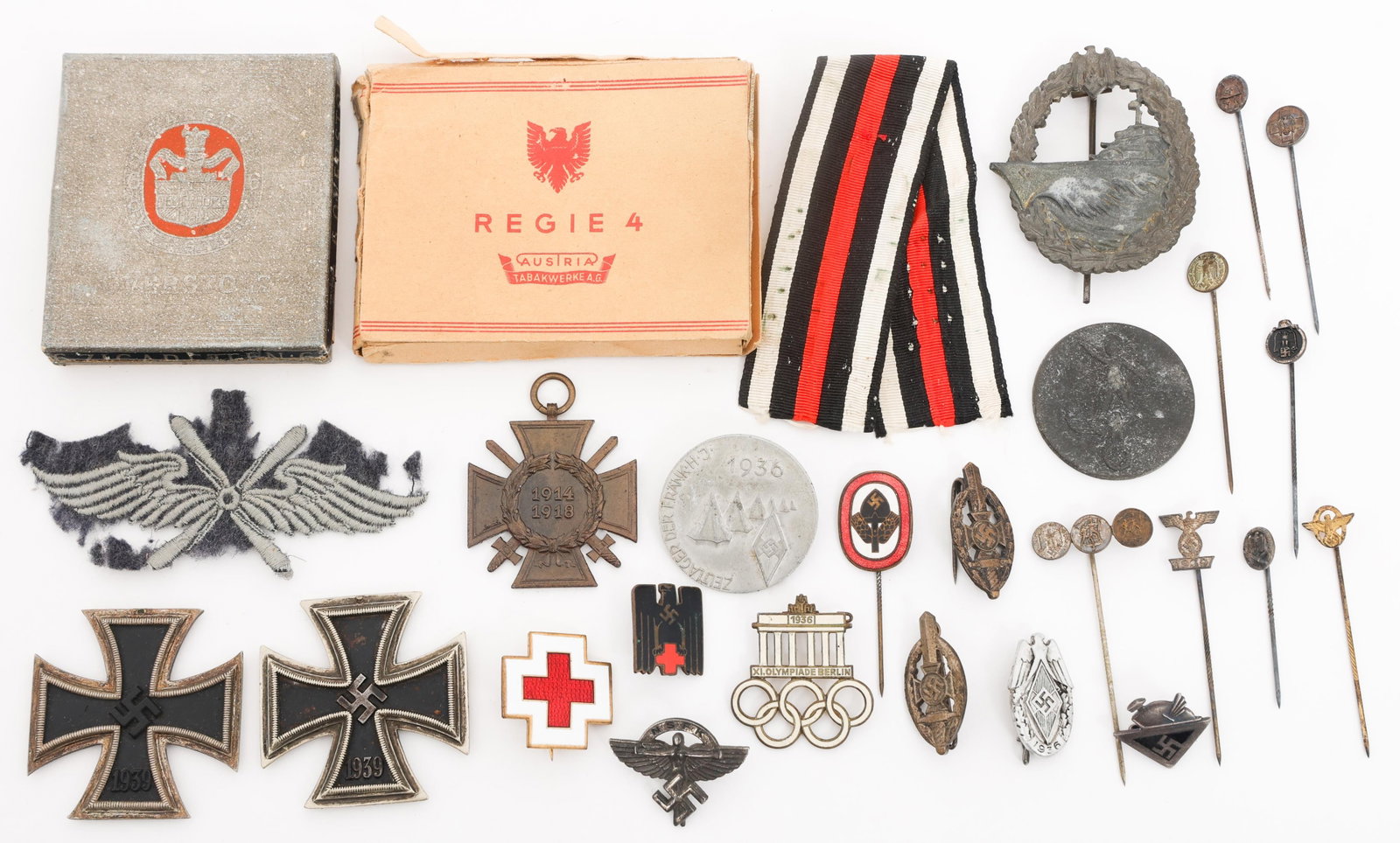 WWII GERMAN HEER MEDALS, BADGES & CIGARETTES: WWII GERMAN HEER MEDALS, BADGES & CIGARETTES WWII German Heer Medals, Badges and Cigarettes. Includes Iron Cross Second Class Medals, 10 pack of Regie 4 Cigarettes, 6 Pack of Overstolz Cigarettes, Ber