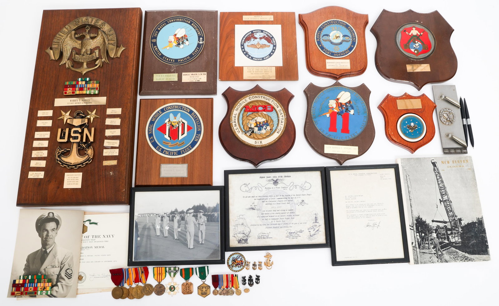 WWII - VIETNAM WAR US NAVY NAMED MCB GROUPING: WWII - VIETNAM WAR US NAVY NAMED MCB GROUPING WWII to Vietnam War US Navy Named MCB Grouping. Named to CUCM Warren E. Morgan. (1) Retirement plaque commemorating the units he was a member of, and his 