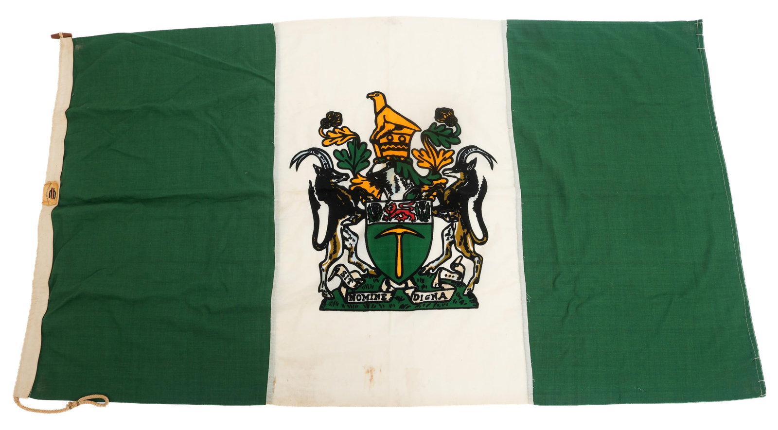 BUSH WAR RHODESIAN NATIONAL UDI FLAG: BUSH WAR RHODESIAN NATIONAL UDI FLAG Bush War Rhodesian National Independence Flag. Double sided, multi piece cotton with printed emblem. Draw rope and wood toggle. Manufacturer tag by William Smith &