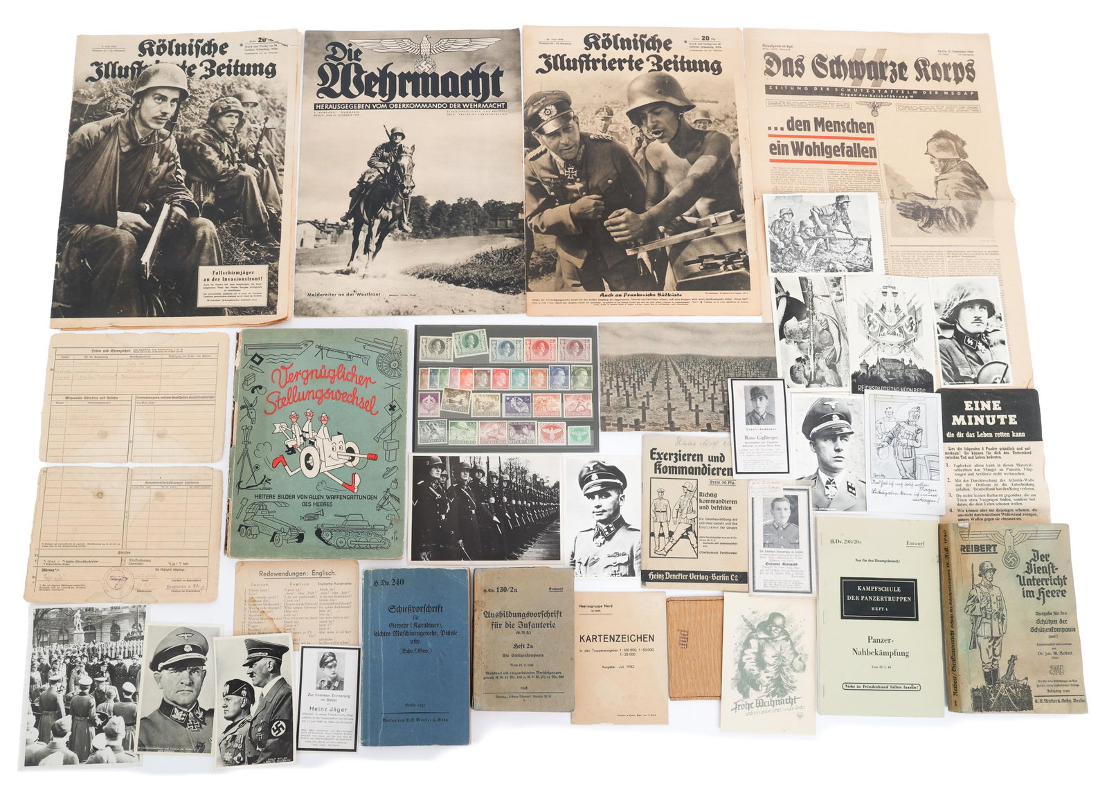 WWII GERMAN NSDAP & HEER PAPER EPHEMERA: WWII GERMAN NSDAP & HEER PAPER EPHEMERA WWII German NSDAP and Heer Instruction Booklets, Soldier Trading Cards, and Propaganda Paper. Includes four issues of German newspapers "Die Wehrmacht" and