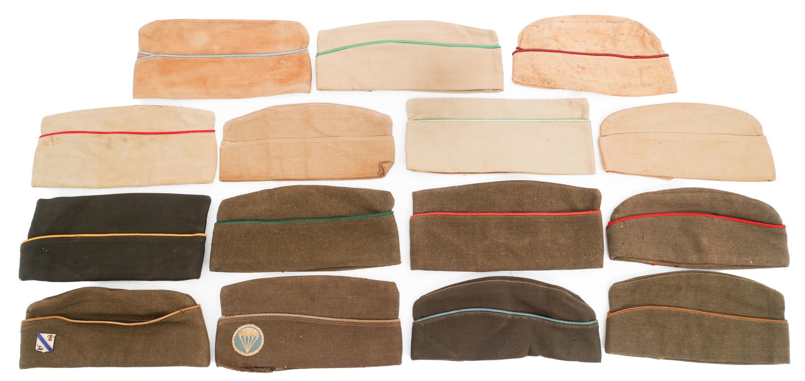 WWII US ARMY KHAKI COTTON & WOOL GARRISON CAPS: WWII US ARMY KHAKI COTTON & WOOL GARRISON CAPS WWII US Army Garrison Caps. Khaki cotton and wool. Insignia includes Paratrooper and Quartermaster School. Various sizes, piping colors and maker marks.