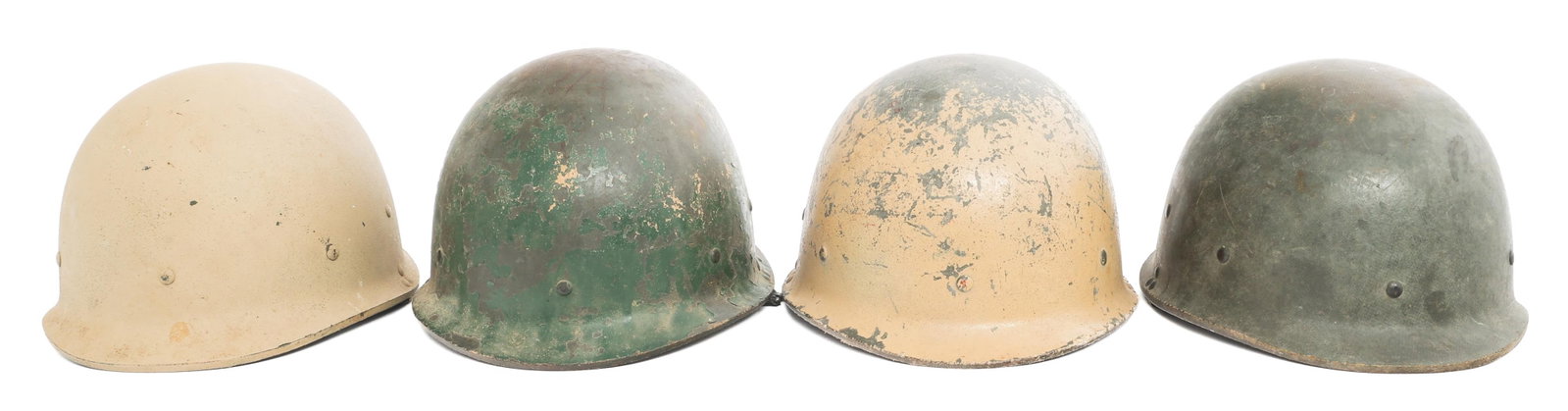 GULF WAR IRAQI ARMY M80 COMBAT HELMETS: GULF WAR IRAQI ARMY M80 COMBAT HELMETS Gulf War Iraqi Army M80 Combat Helmets. (4) Helmets. Green and khaki painted fiber. Two complete and two partial suspension liners, all have chinstraps. Arabic