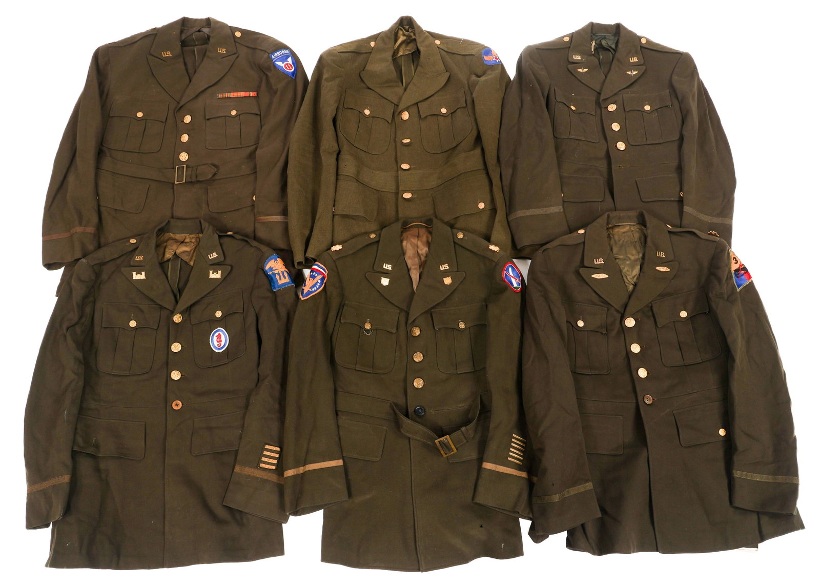 WWII US AIRBORNE & OD ELASTIQUE OFFICER TUNICS: WWII US AIRBORNE & OD ELASTIQUE OFFICER TUNICS WWII US OD and Chocolate Elastique Service Tunics. (1) OD Service Tunic. USAAF shoulder patch. Tag. (5) Chocolate Elastique Service Tunics. Patches inclu