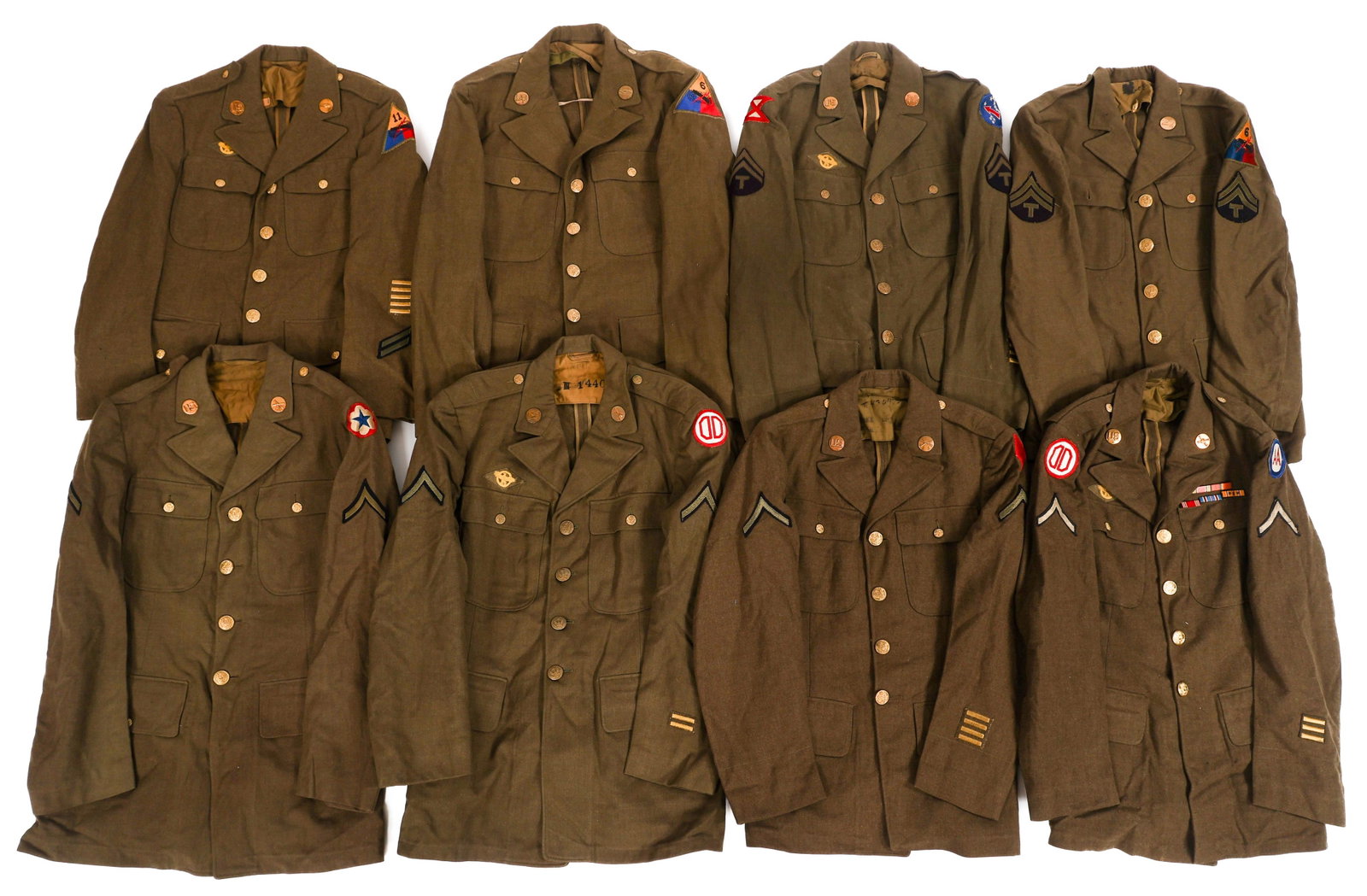 WWII US ARMORED CORPS & US ARMY EM/NCO TUNICS: WWII US ARMORED CORPS & US ARMY EM/NCO TUNICS (8) WWII US Army Enlisted Man and NCO OG Wool Serge Service Tunics. Patches include 31st Infantry Division, 6th Armored Division, 11th Armored Division, 6