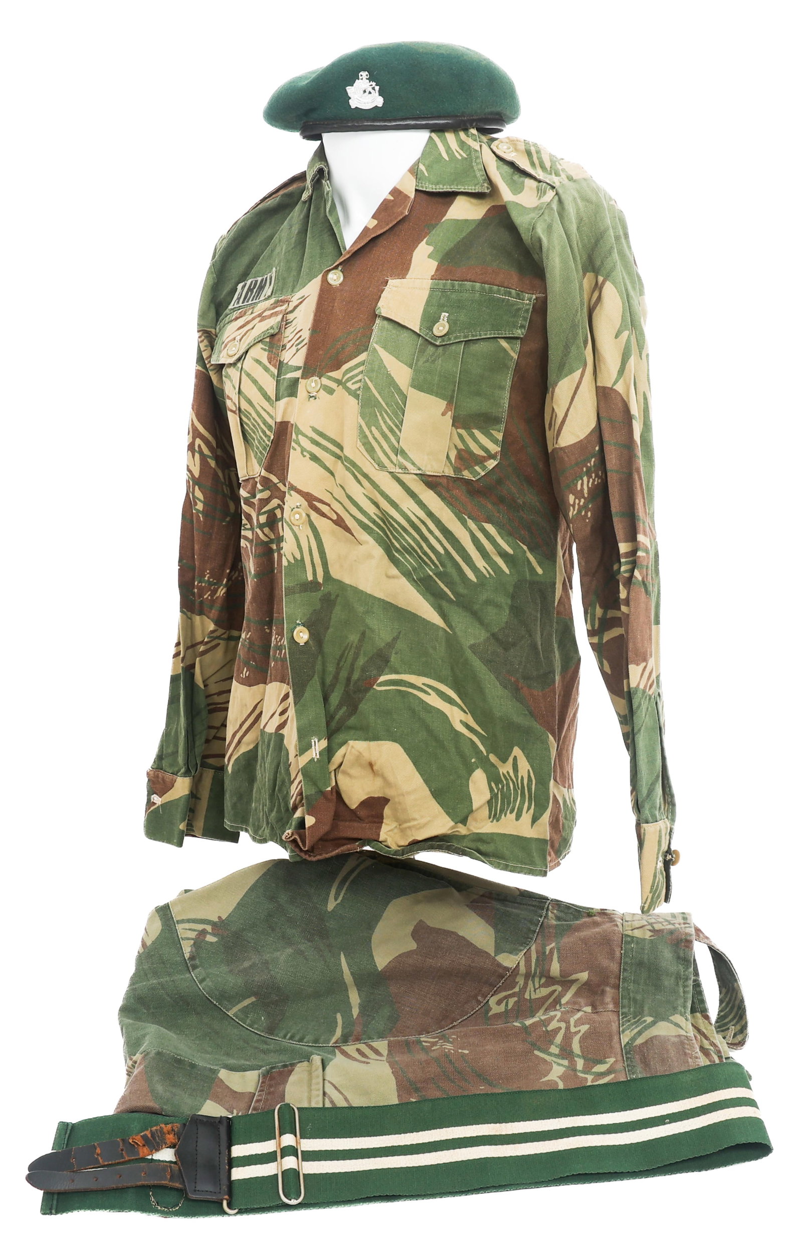 BUSH WAR RHODESIAN BRUSHSTROKE RLI UNIFORM: BUSH WAR RHODESIAN BRUSHSTROKE RLI UNIFORM Bush War Rhodesian Brushstroke Camouflage Light Infantry Uniform. Includes (1) Green wool beret. RLI insignia. Leather insignia flap marked P.M. on the